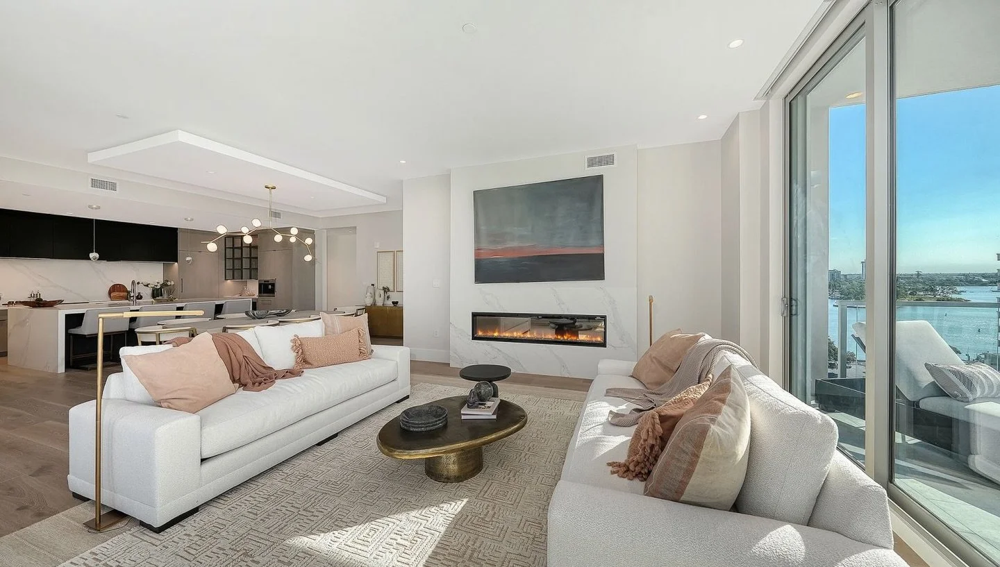 Sunlight, water views, and effortless elegance. ✨
This open-concept living space blends modern design with warm, livable luxury&mdash;where mornings start with coffee overlooking the bay and evenings unwind by the fire.

Imagine entertaining here, wi