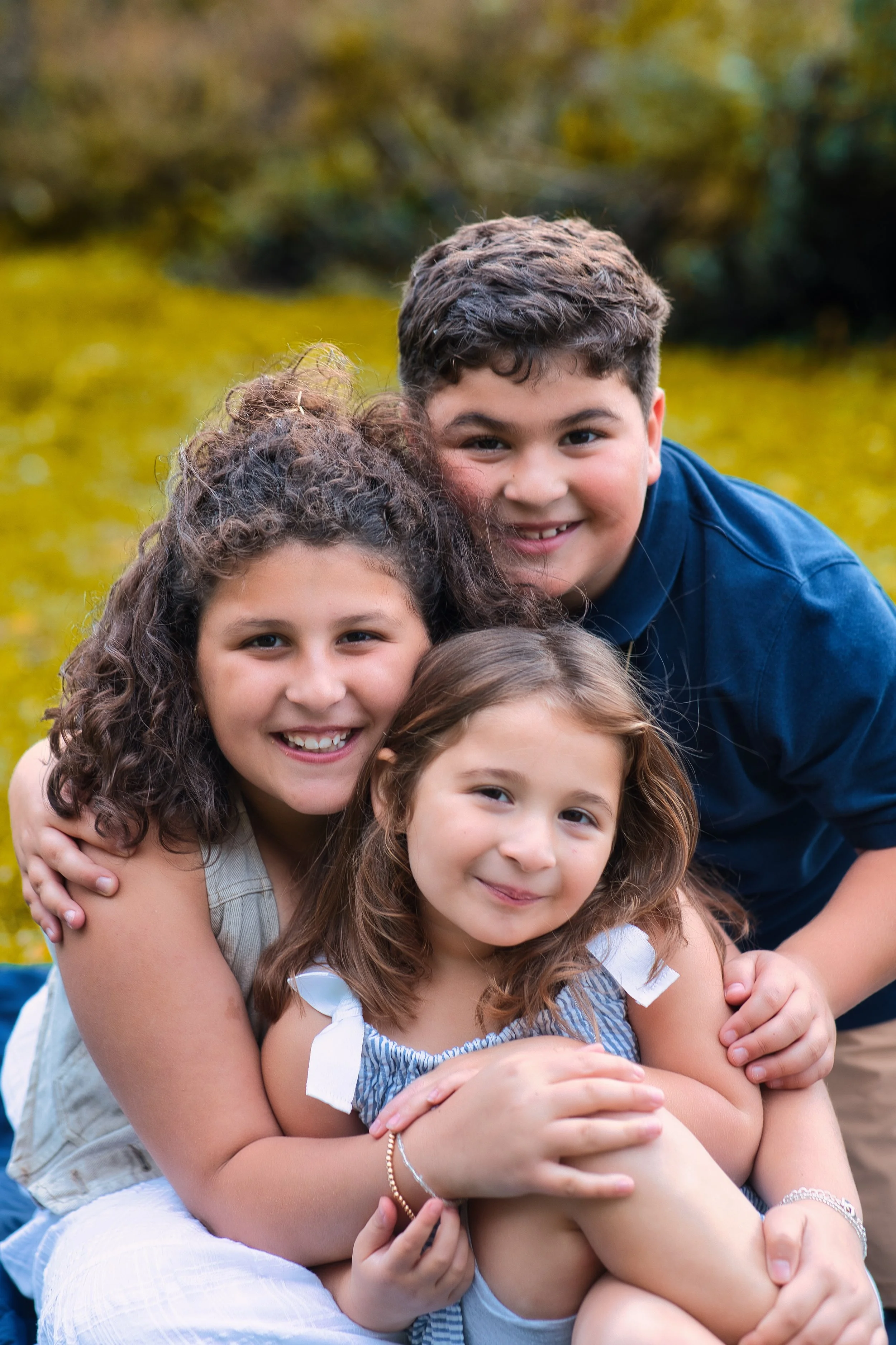 Rochester, NY sibling portrait of three children smiling together outdoors