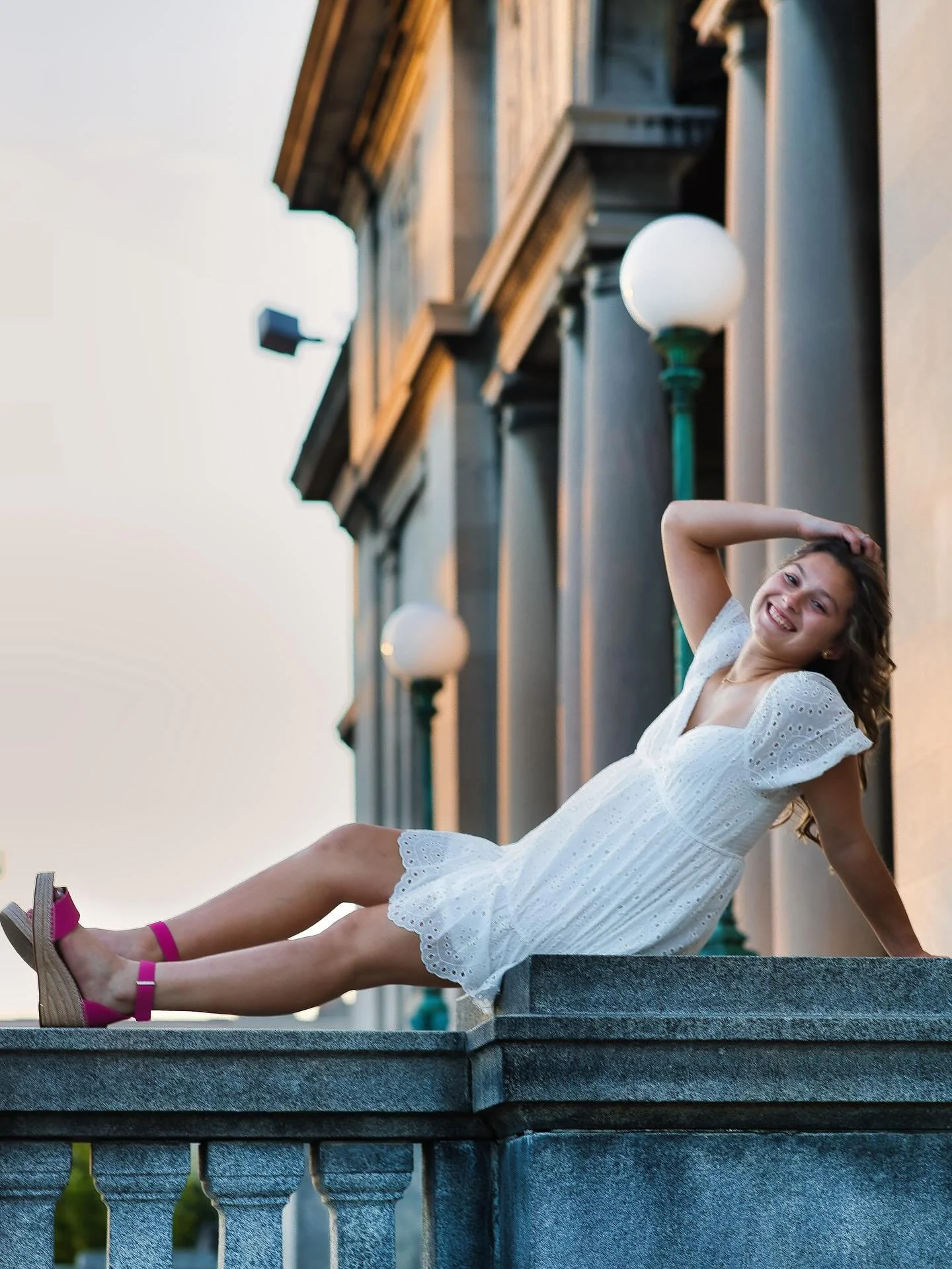 enior girl in white dress posing dramatically on stone steps, Memorial Art Gallery Rochester NY senior portraits