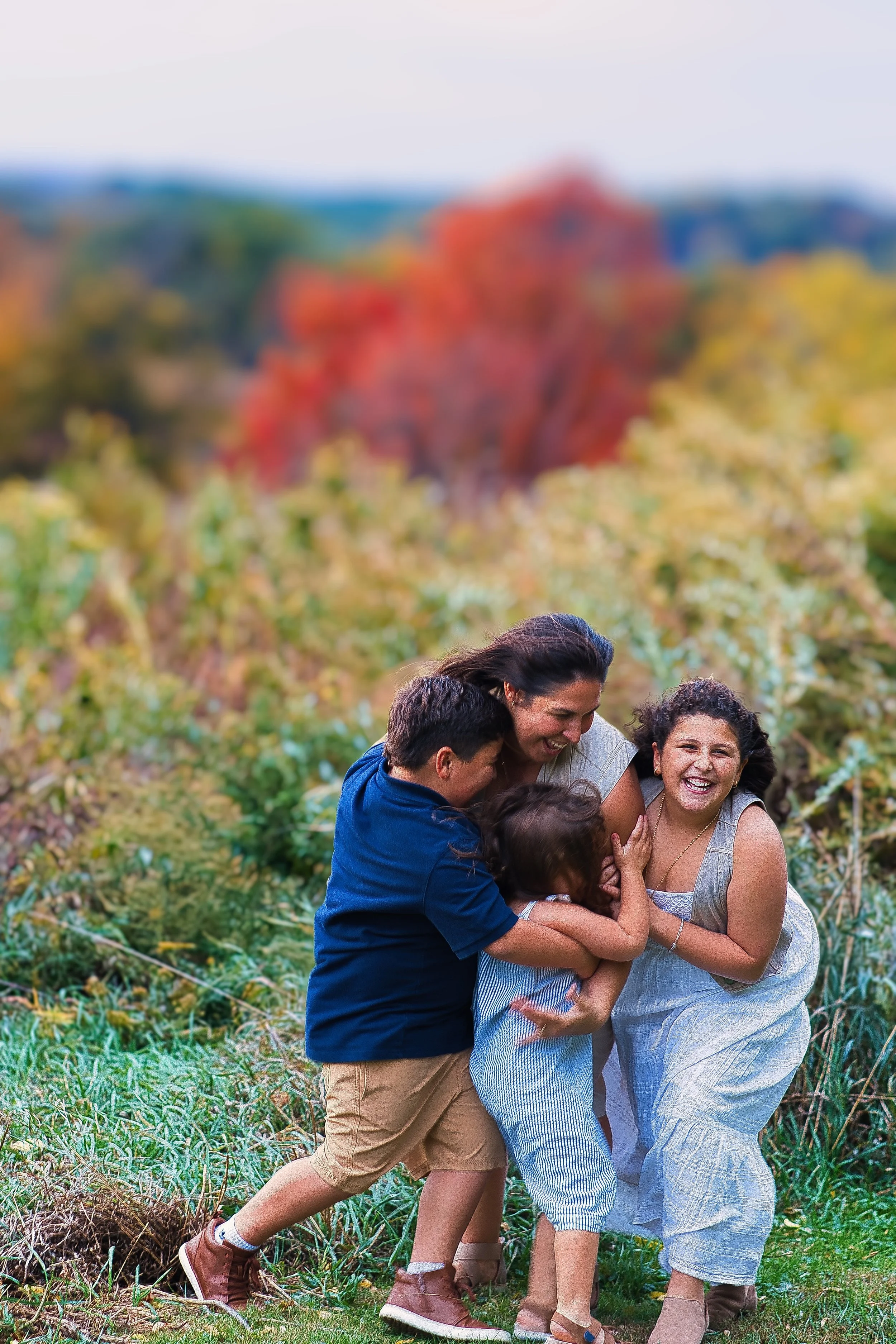 Rochester, NY candid family portrait of mother and children playing together outdoors in fall