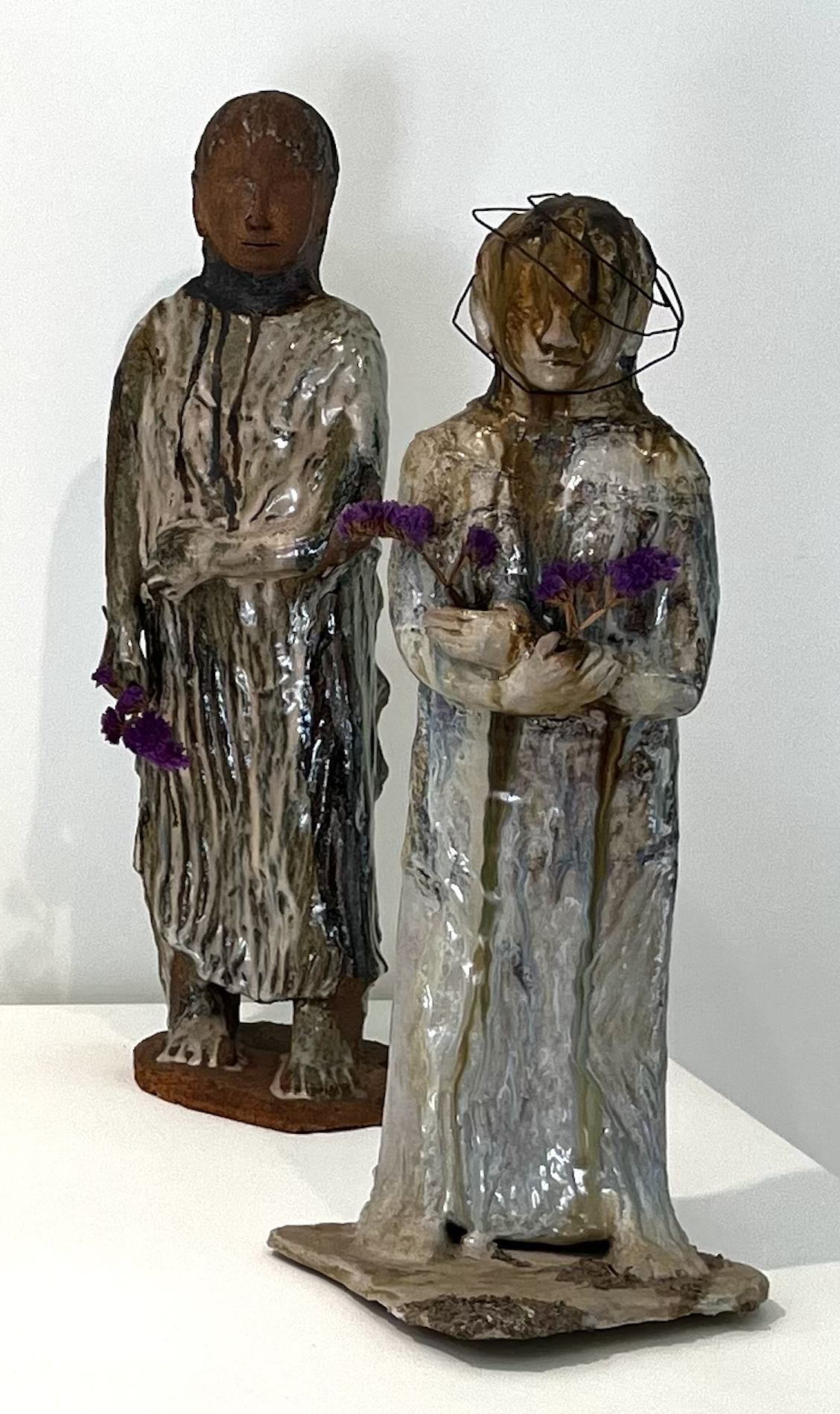 (Left) Ada Pilar Cruz, Standing Figure
Stoneware, 19" x 8" x 7"

(Right) Ada Pilar Cruz, Figure with Wire Crown, 25" x 9" x 9"