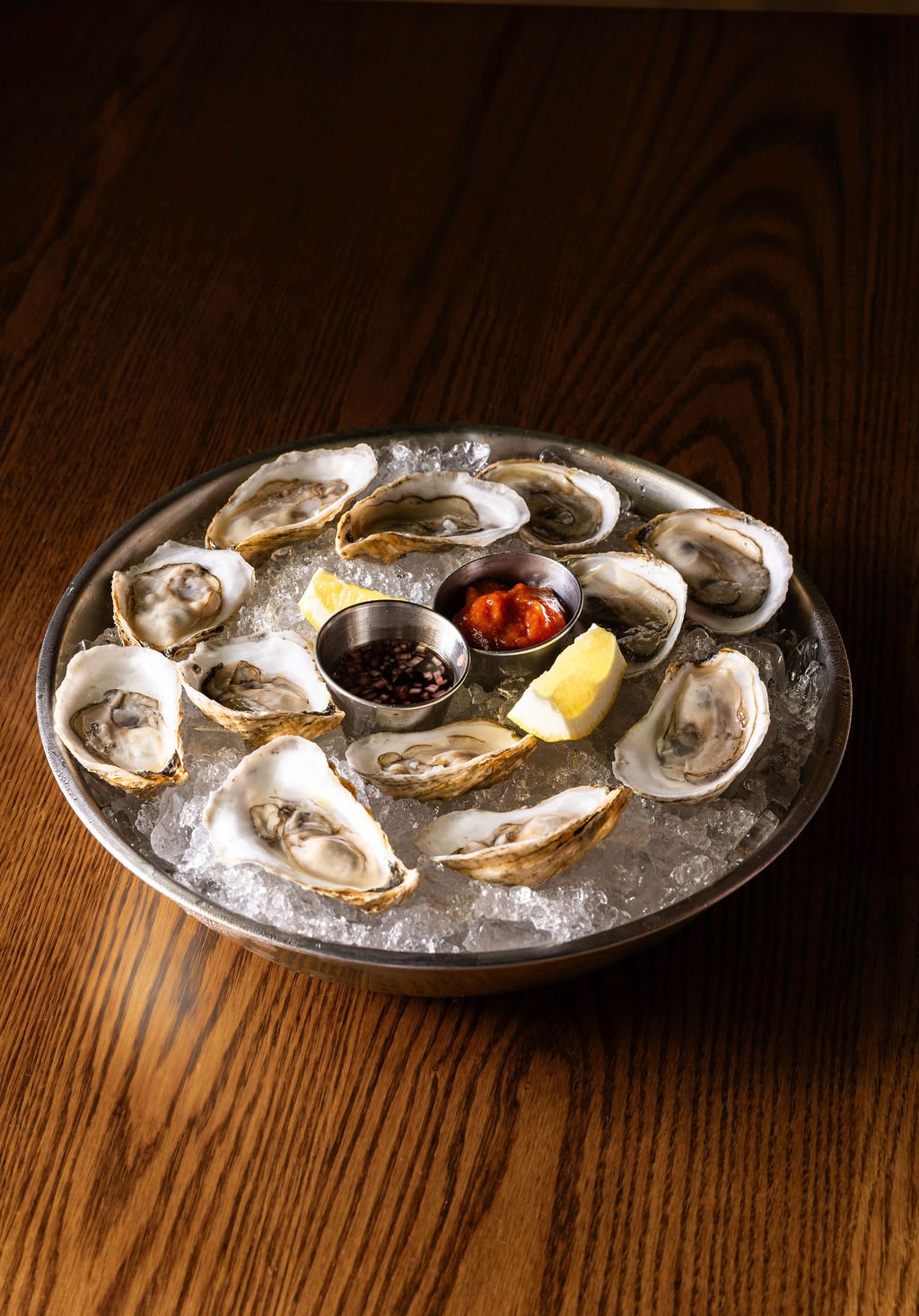 12 oysters over ice on a tray