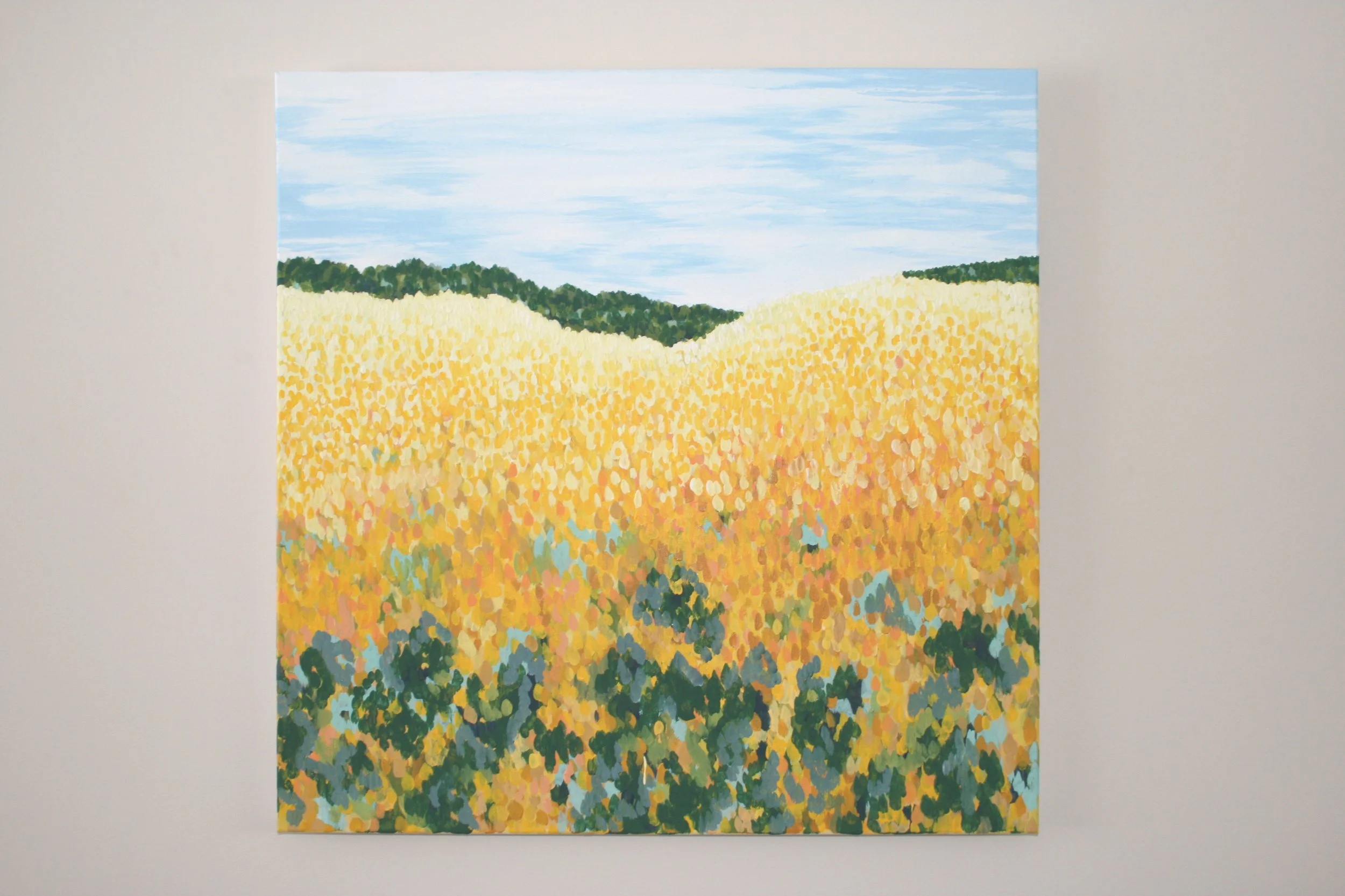 Commissioned landscape painting by Rebekah Victoria featuring a sunny day over rolling fields of yellow flowers. The artwork captures warmth, joy, and the vibrant beauty of nature with rich color and detailed texture.