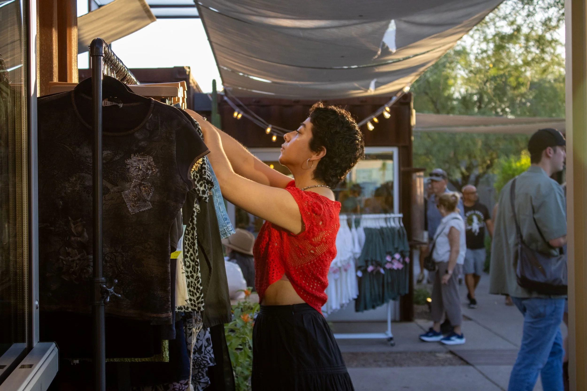 ORTENSE staff prepping a vintage clothing rack outside the shop for an MSA Annex outdoor market.