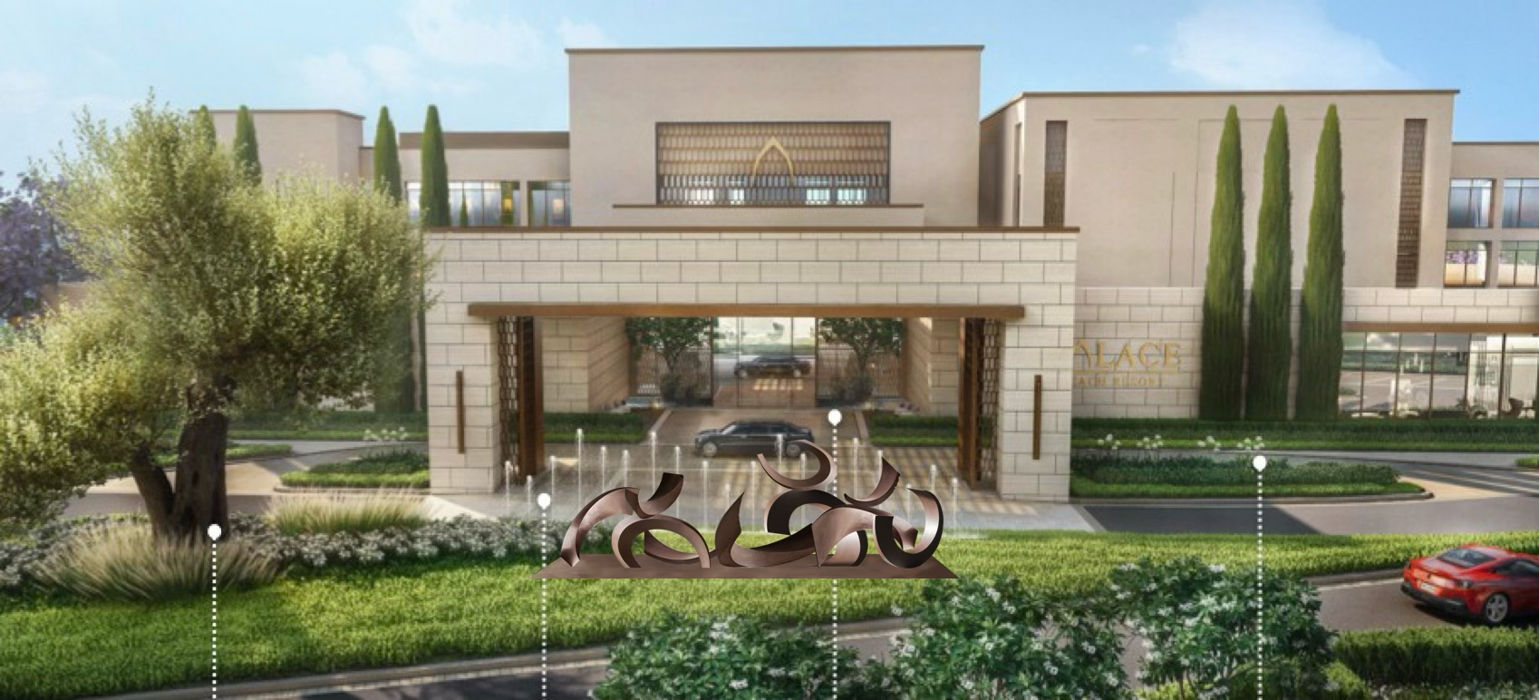 Modern residential community entrance with landscaped greenery, metal sculpture of abstract shapes, trees, and parked cars, sign reading 'ALACE ADLER ROCK' on a beige building with large windows.