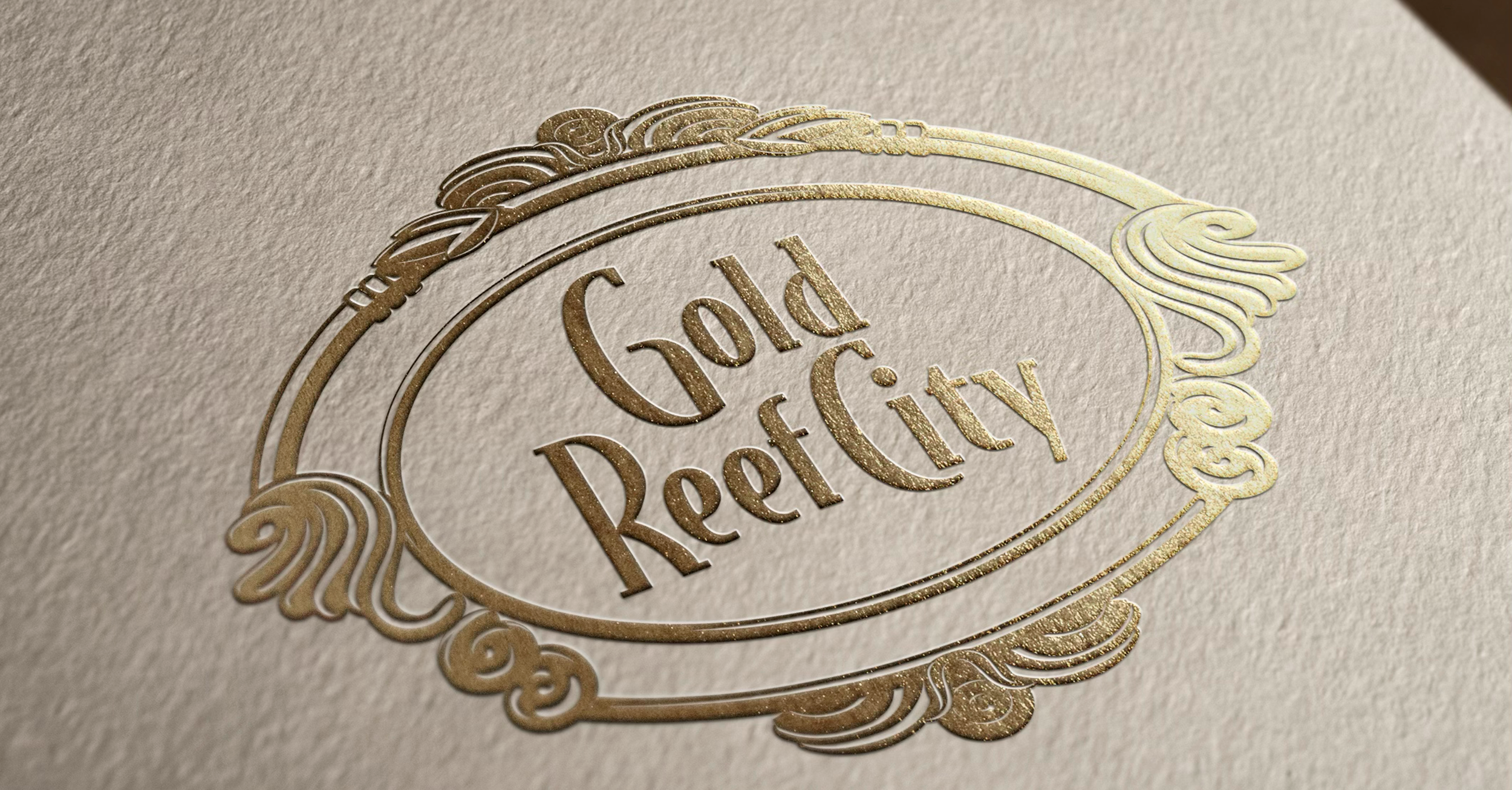 A textured beige paper with an embossed gold logo that says "Old Reefty" in an ornate oval frame with decorative swirls.