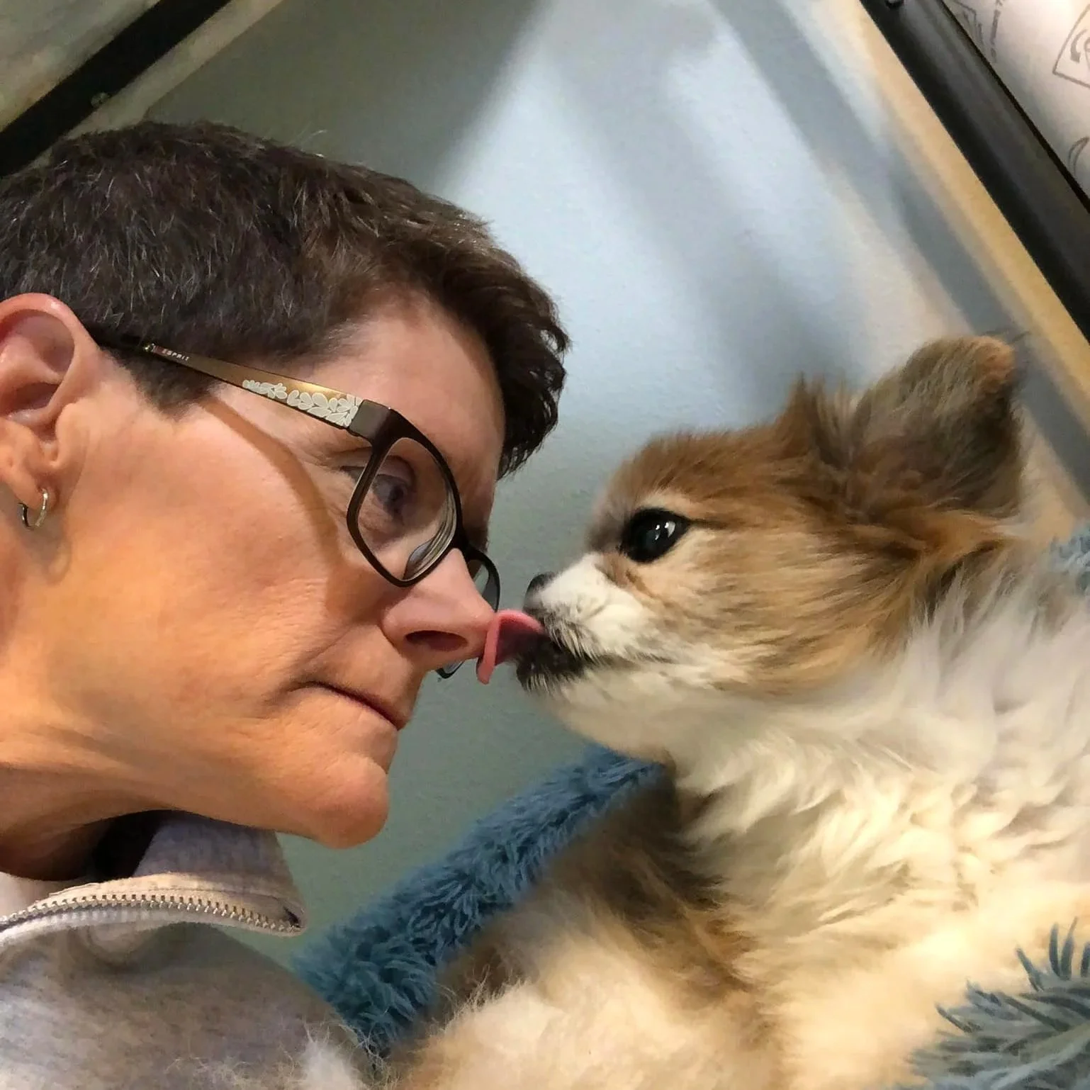 Christina getting kisses from one of their dogs