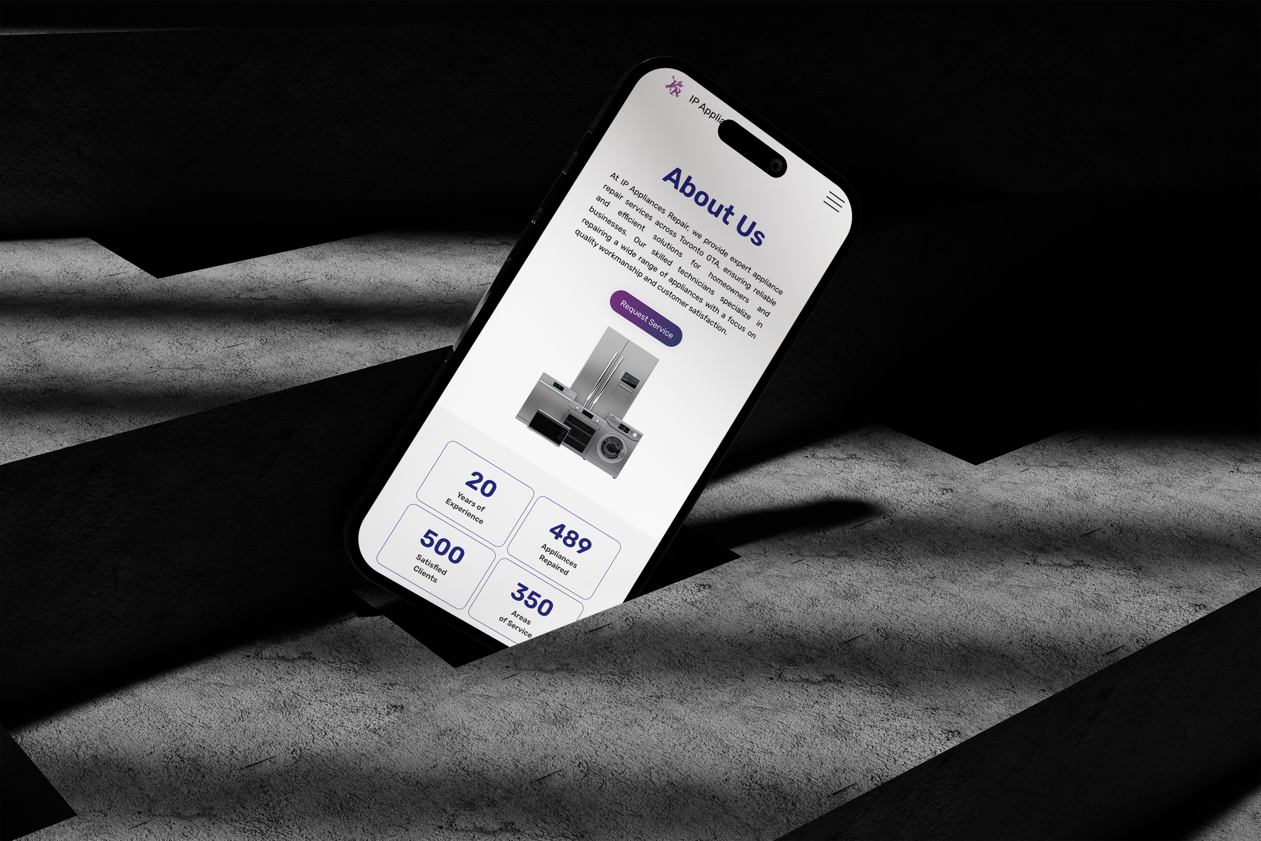 A smartphone displaying the 'About Us' page of a website for an appliance repair service, with a brief description, a purple 'Request Service' button, and statistics about experience, satisfied clients, appliances repaired, and areas of service, all on a textured gray background.