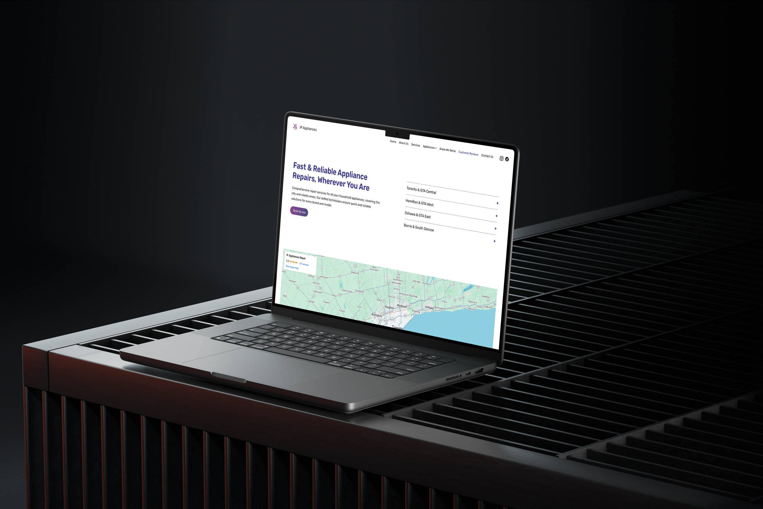Laptop displaying a website for appliance repair services on a black metal grate surface.