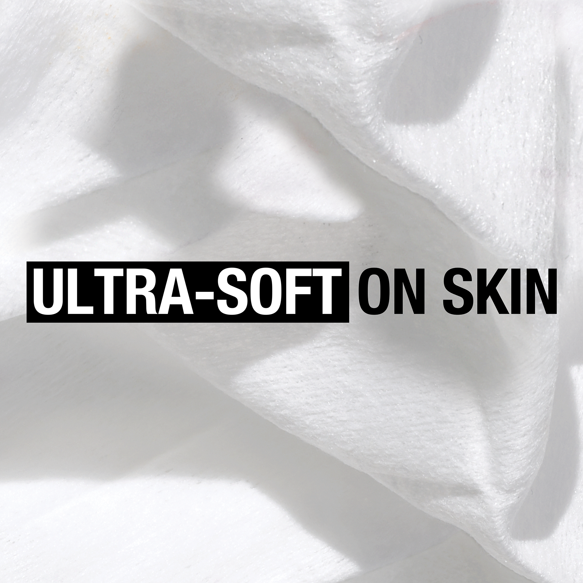 Close-up of white, fluffy fabric with text overlay that says ''ULTRA-SOFT ON SKIN''