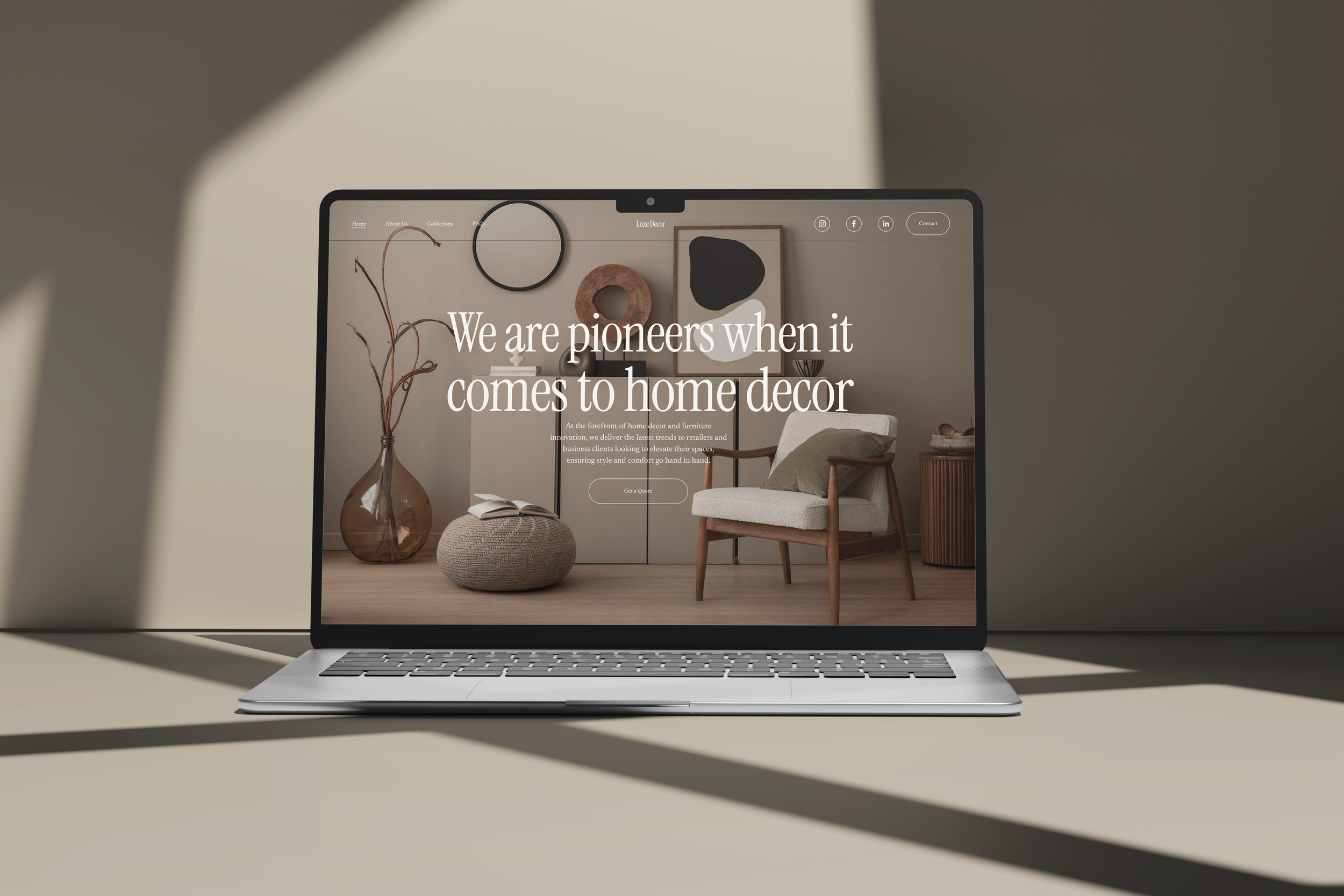 Laptop on a table displaying a home decor website with a background of a living room interior featuring wall art, a chair, and decorative items.