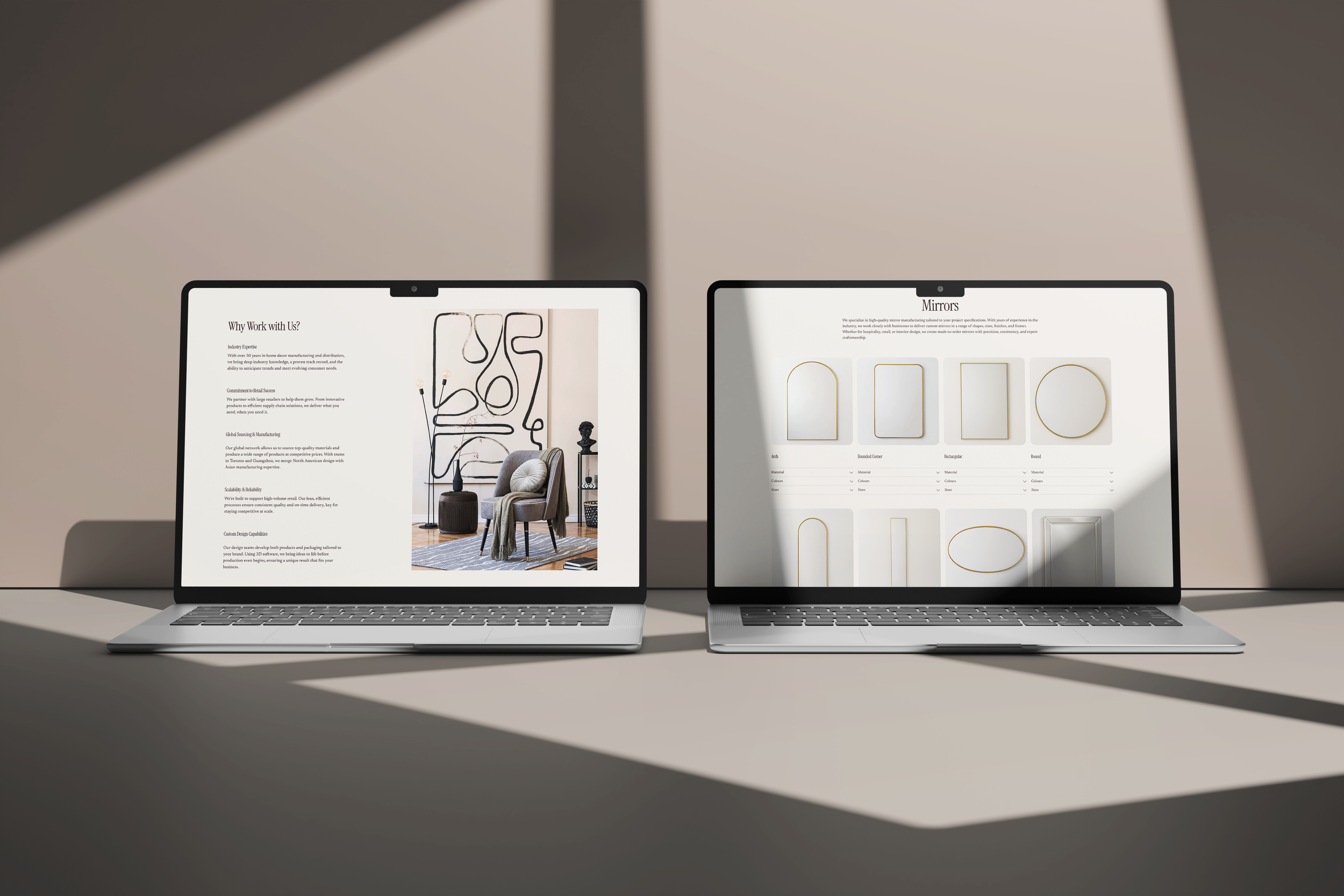 Two laptops on a table displaying a website about furniture and design, with shadows cast across the scene.