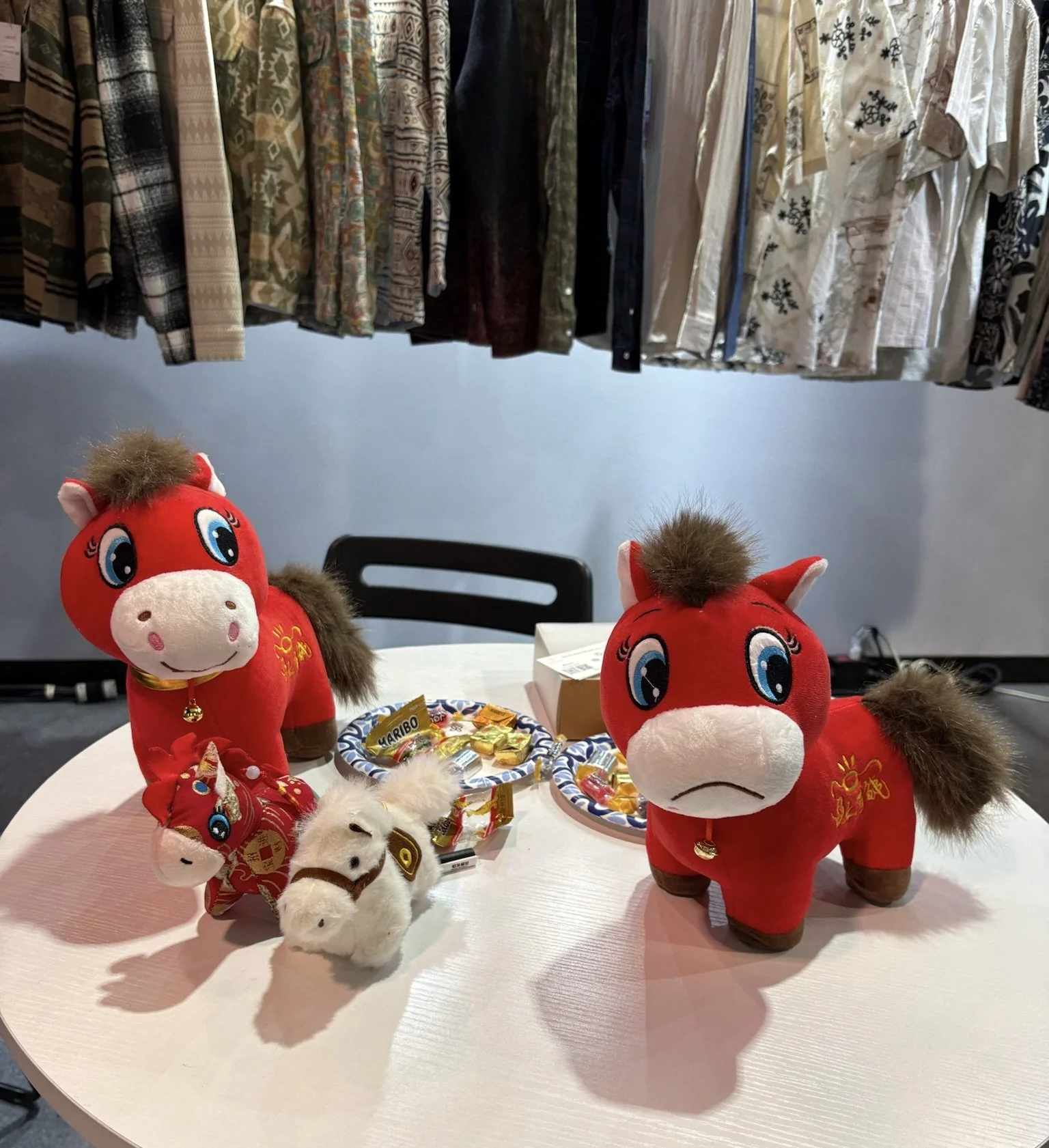 Table at fashion conference, sourcing at Magic by Informa, with stuffed happy horse and Sad horse for Chinese new year