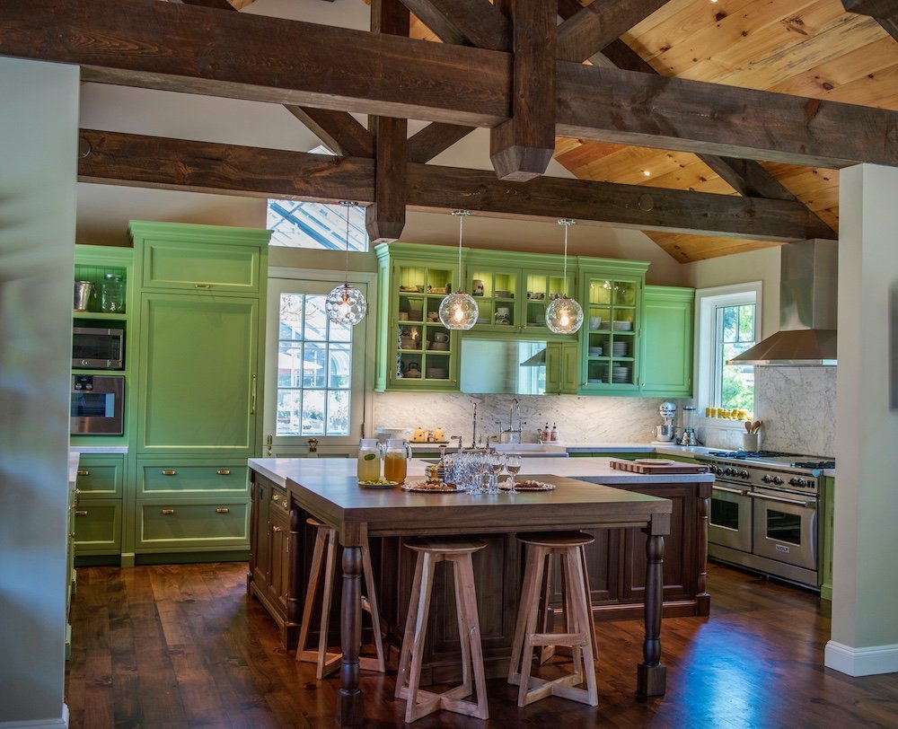 Estate Kitchen with green cabinets and reclaimed ceiling beams.