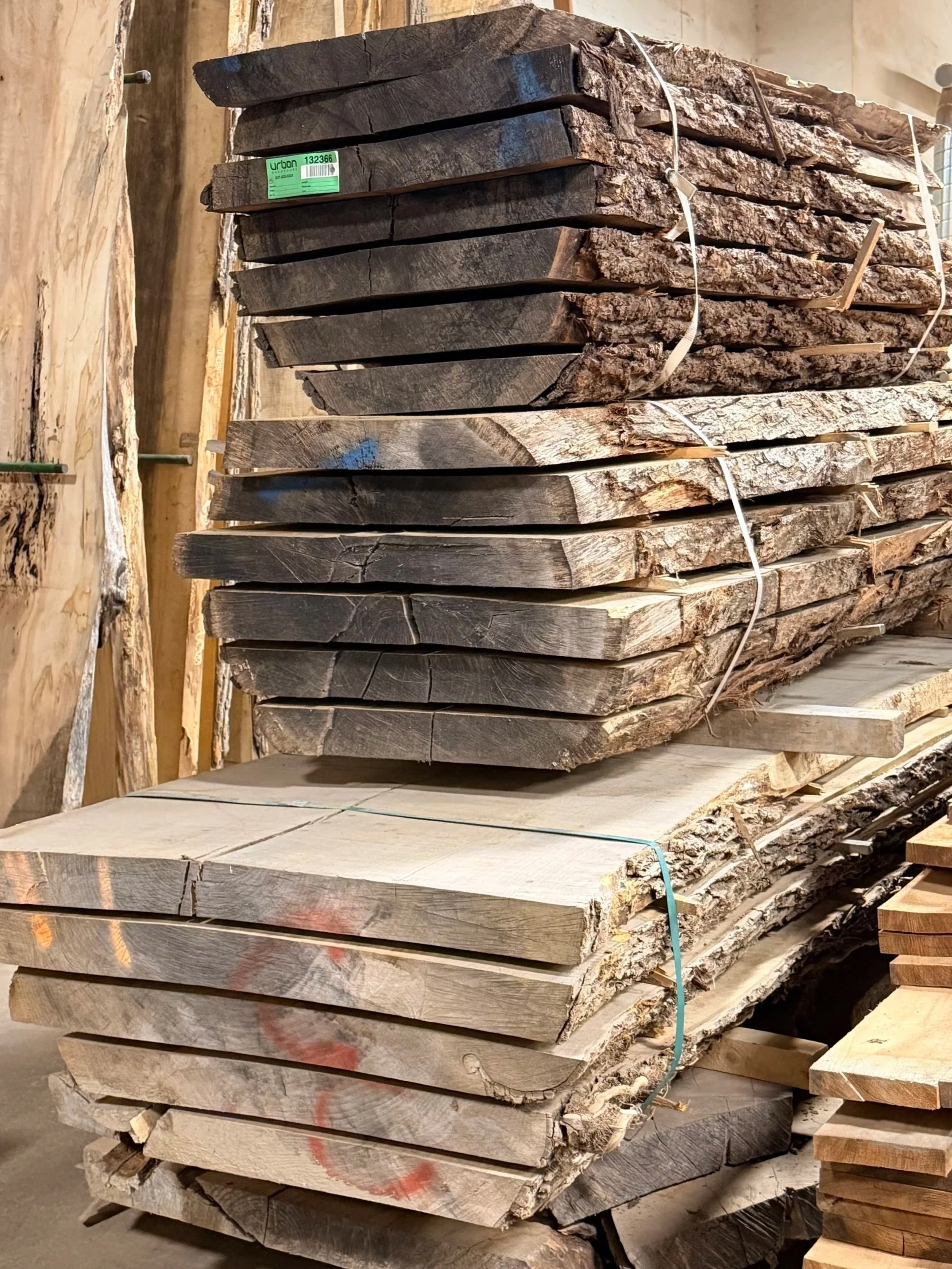 Two boules of walnut live edge slabs stacked on top of each other.
