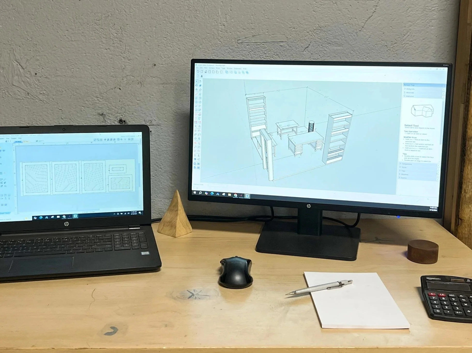 Two computers showing designs that will be fabricated on the CNC