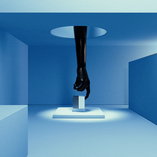 A black mannequin leg and foot hanging upside down through a circular hole in the ceiling, positioned above a white pedestal in a minimalist room with blue walls and lighting.