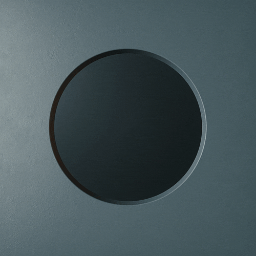 Close-up of a circular button or sensor on a gray surface