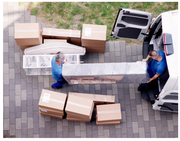 two men moving boxes into a van