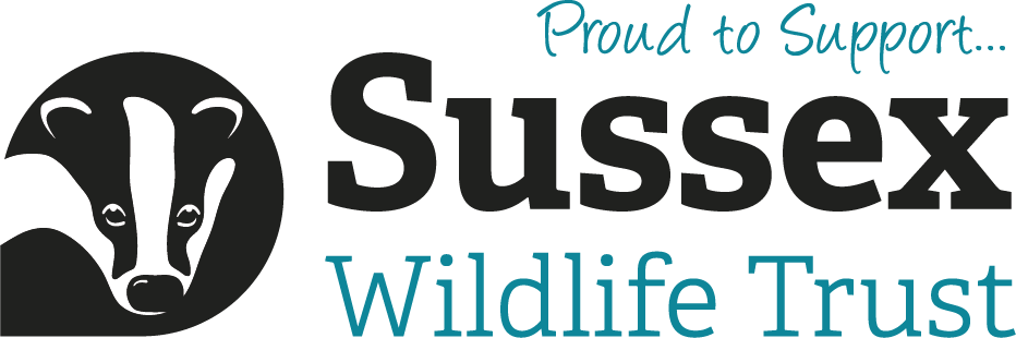 Logo for Sussex Wildlife Trust featuring a black and white illustration of a badger's face, with the text "Proud to Support... Sussex Wildlife Trust".