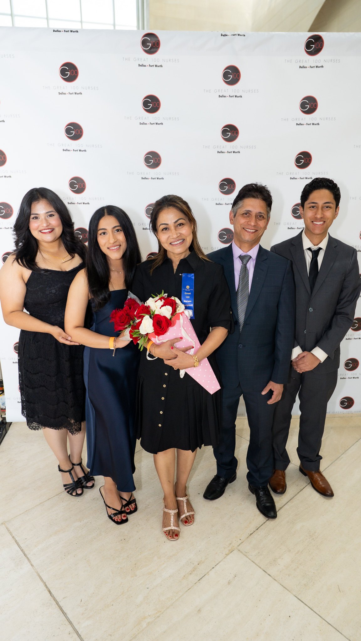A moment years in the making. Surrounded by her husband and children, this Great 100 Nurses honoree holds more than just flowers—she holds the pride of a family who’s witnessed the sacrifices, strength, and heart behind her excellence.