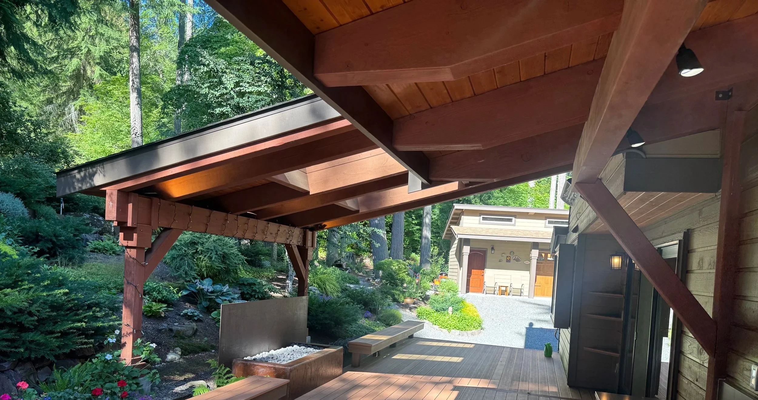 Redmond outdoor living space with built-in deck seating, gas fire feature, cedar tongue-and-groove soffit and integrated lighting