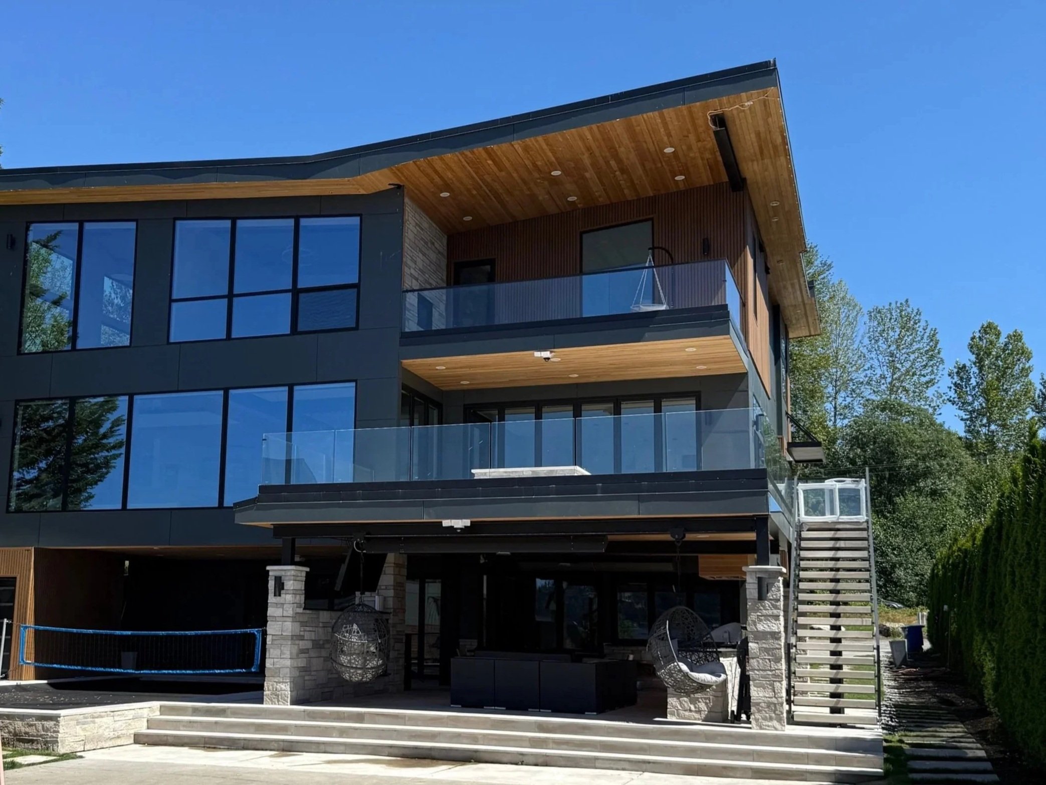 Frameless glass deck railing on a modern multi-level home