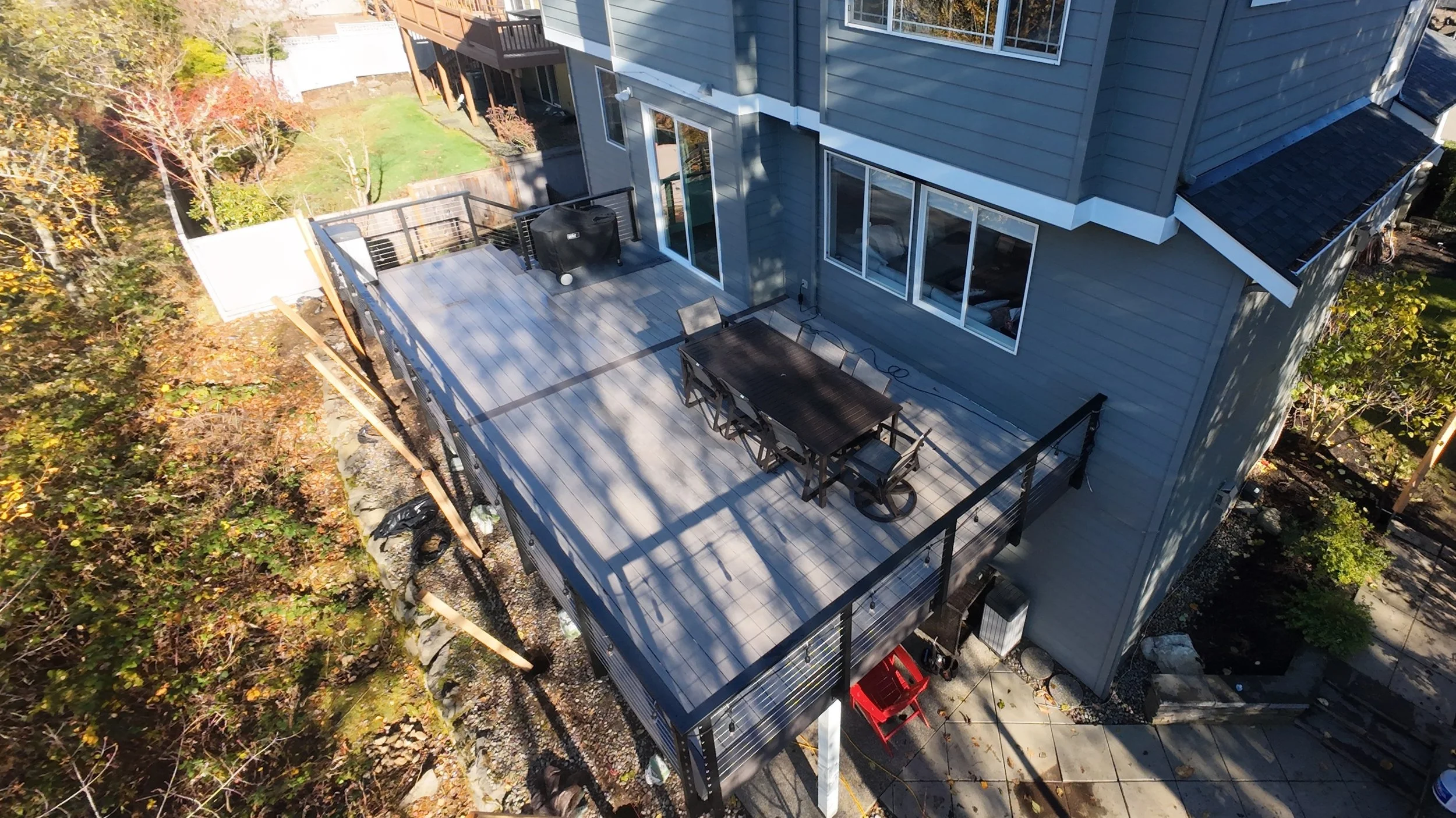 Expanded elevated deck in Sammamish WA featuring AZEK Coastline decking, Dark Hickory border and fascia, and cable railing.