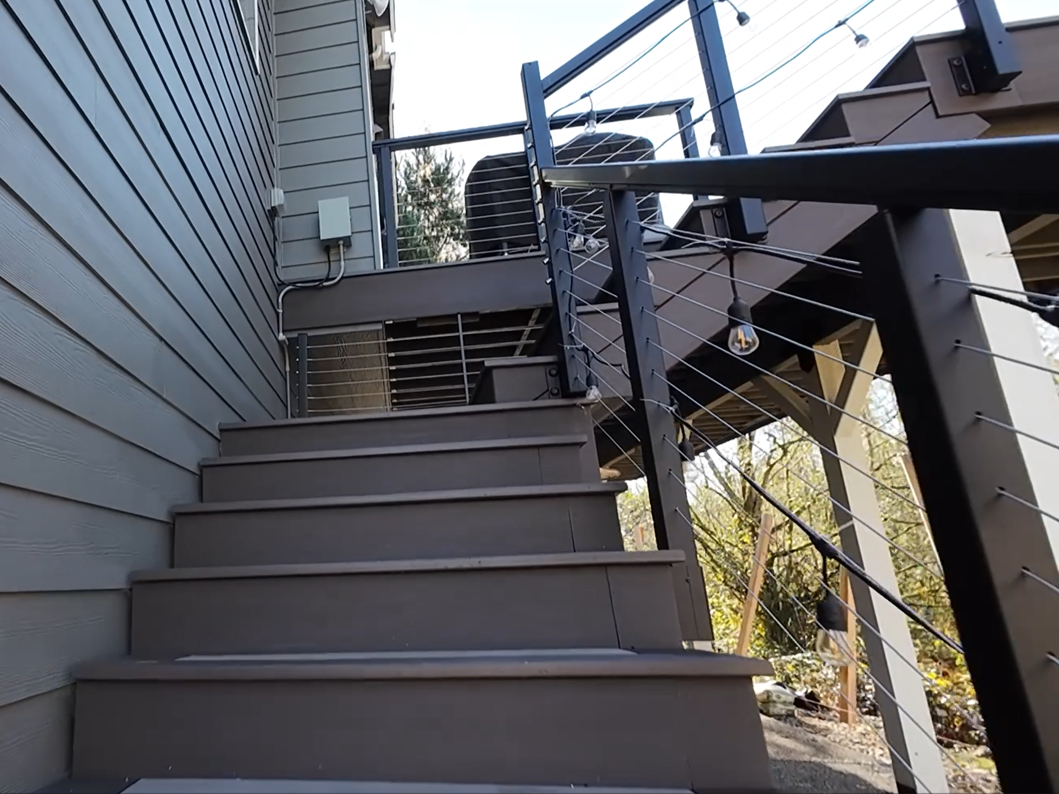 Modern deck stairs with cable railing at a Sammamish AZEK deck remodel