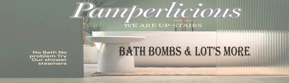 Store sign with the words 'Pamperlicious, We Are Up-Stairs', and 'Bath Bombs & Lot's More', with a bathtub display and a small sign mentioning shower steamers.