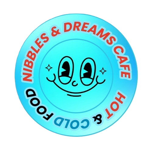 A round blue logo with a smiling face and starry eyes, featuring the text 'Nibbles & Dreams Cafe' and 'Hot & Cold Food' in red and blue around the edge.