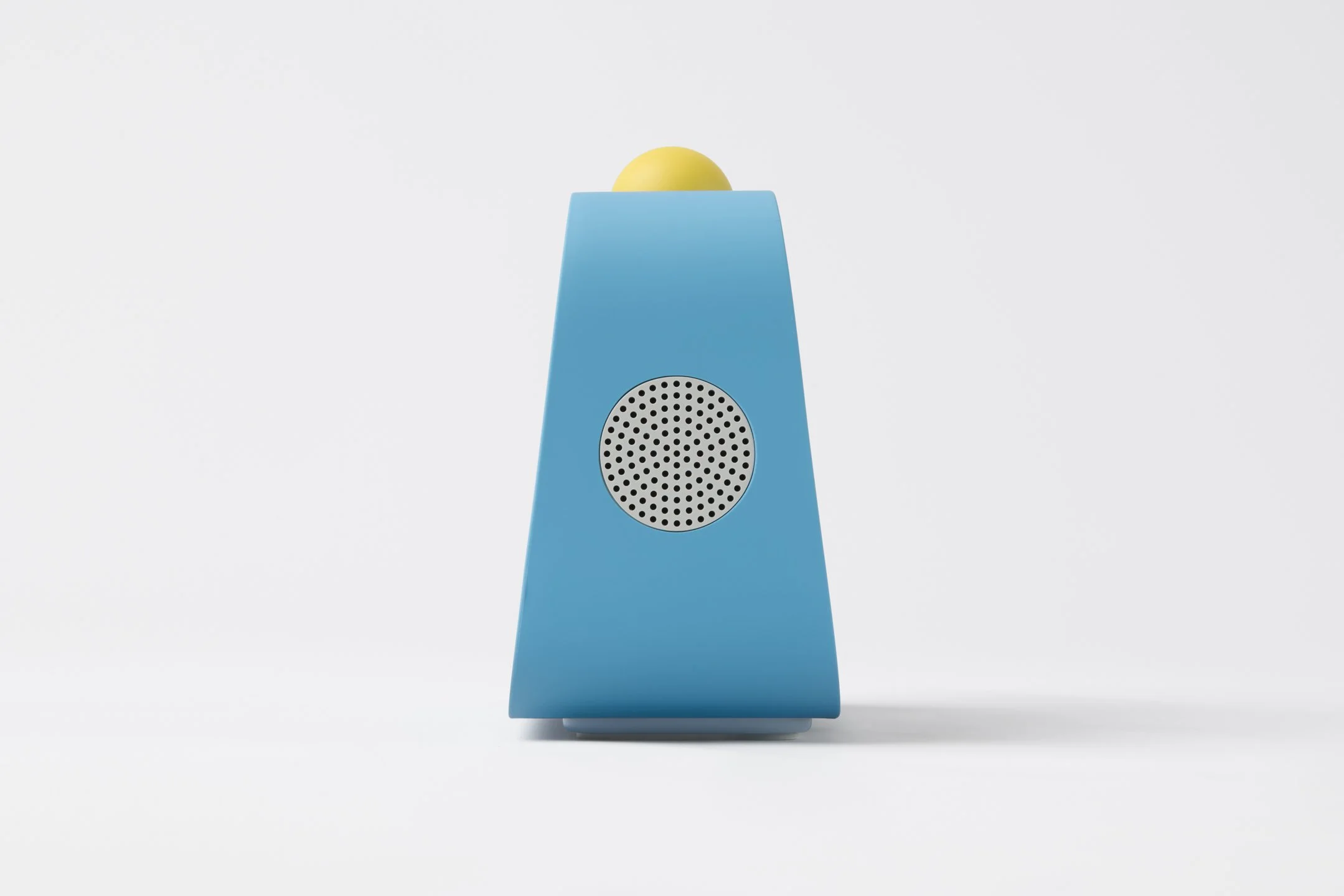 Wedge shaped device with speakers on the side and large yellow button on top