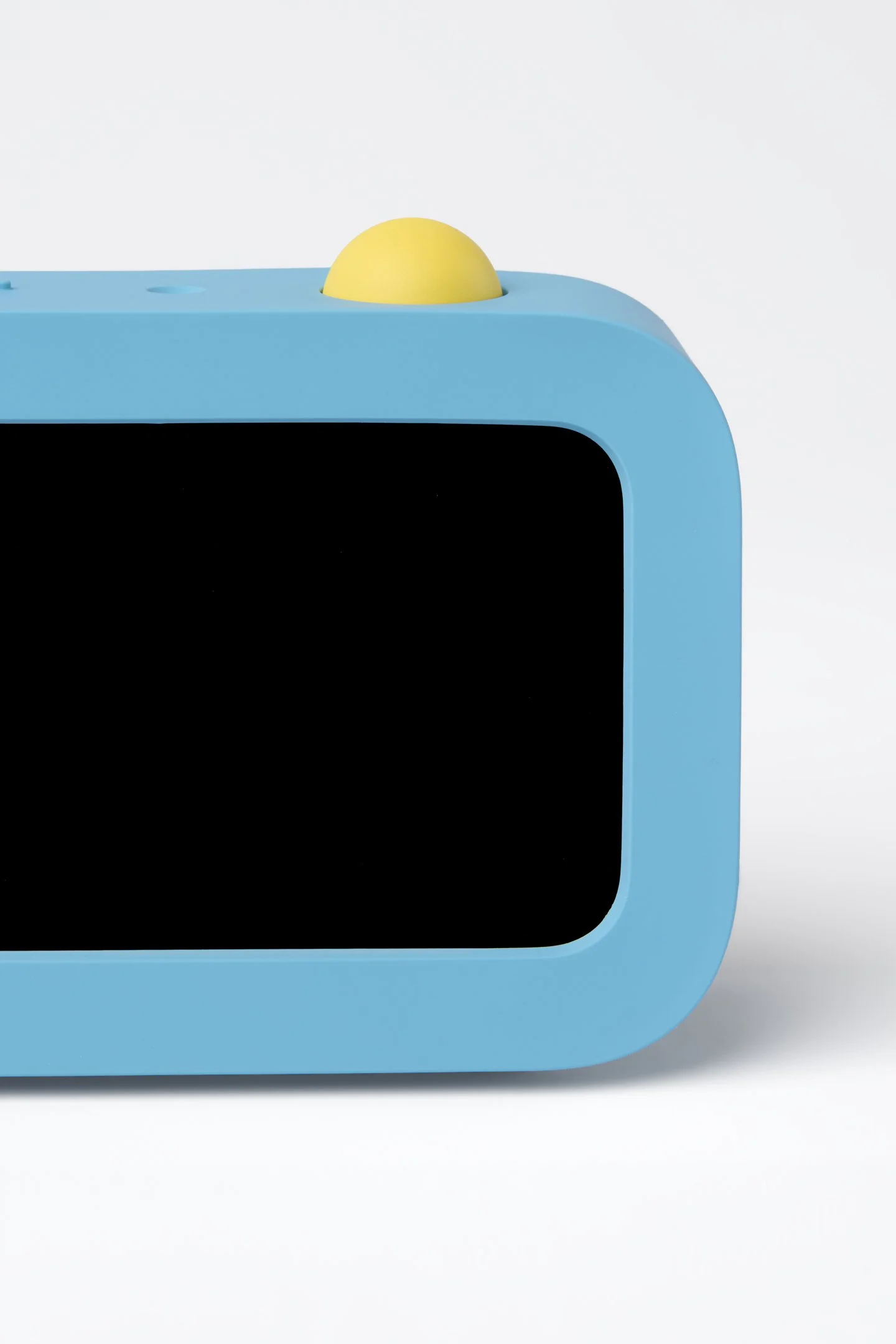 Blue task tracking device for children featuring a screen and large yellow button
