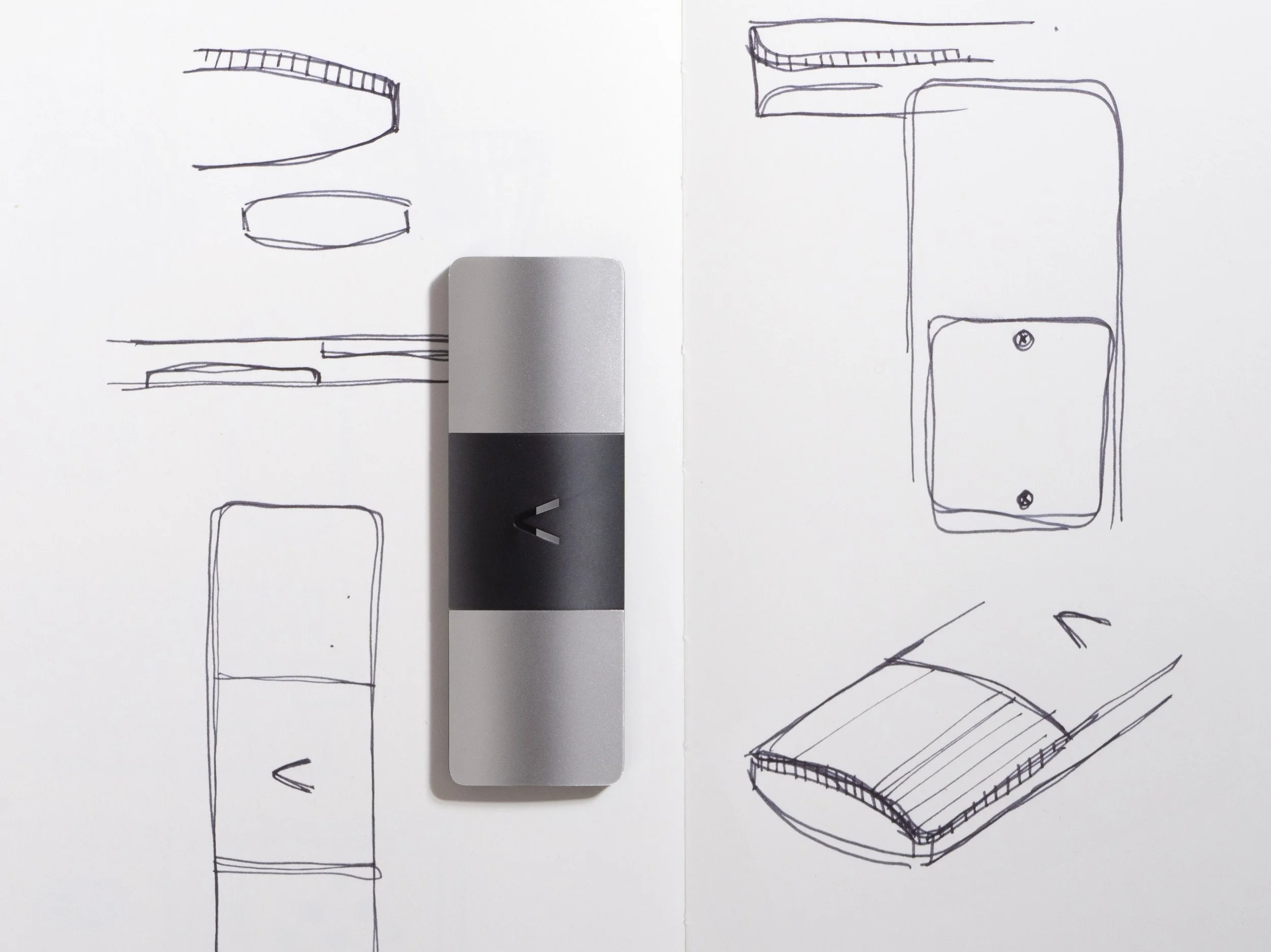 Hand-drawn sketches of various objects on white paper with a ECG device placed on top.
