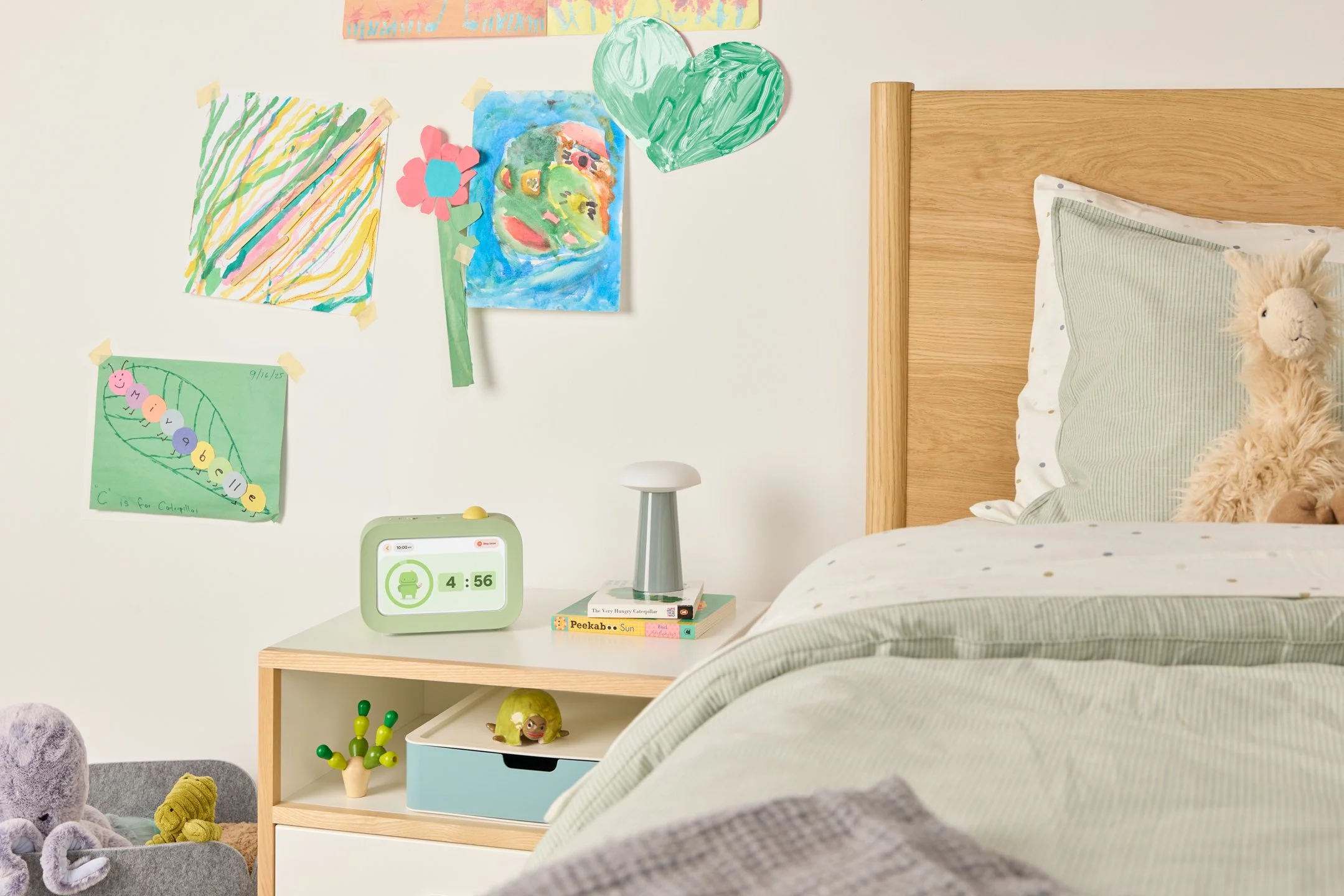 Green device with yellow button used to help children track tasks throughout the day.