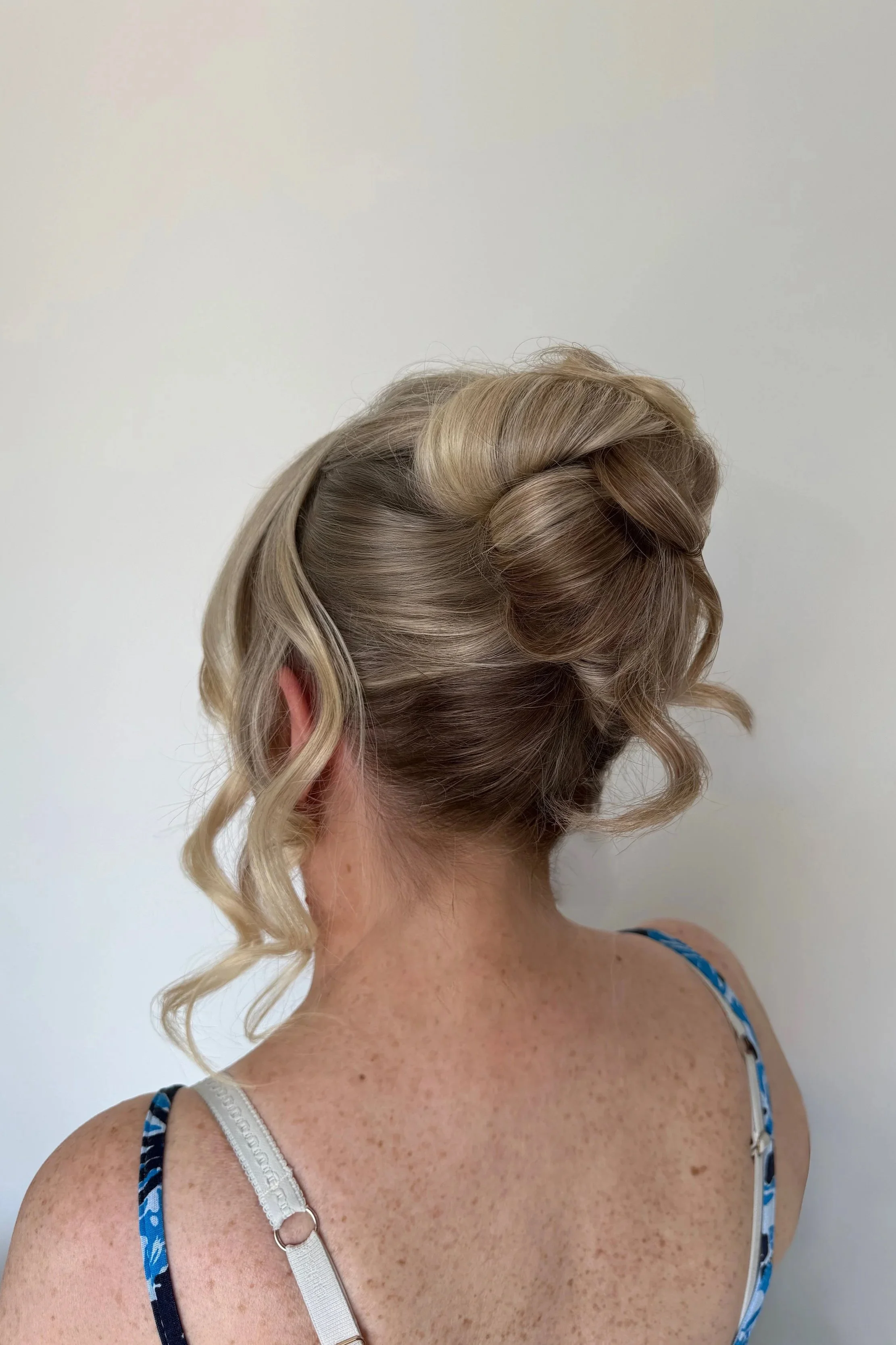 Wedding guest hair styled in a romantic undo