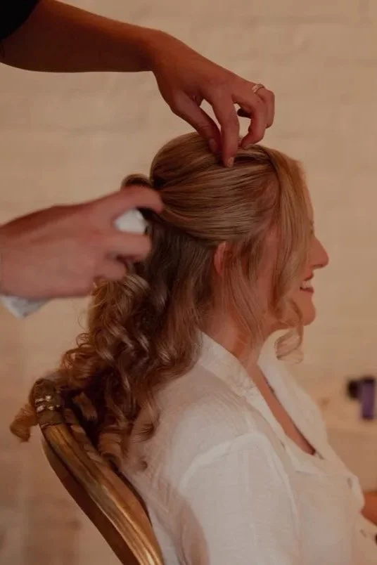 Bride getting her hair done by Nathan on her wedding day. Styled into a half up half down style