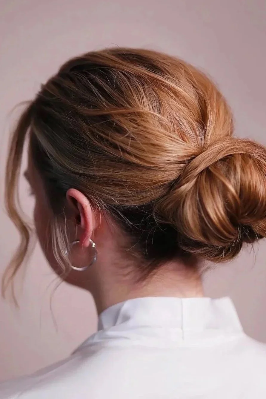Bridal hair styled in a low twisted bun.