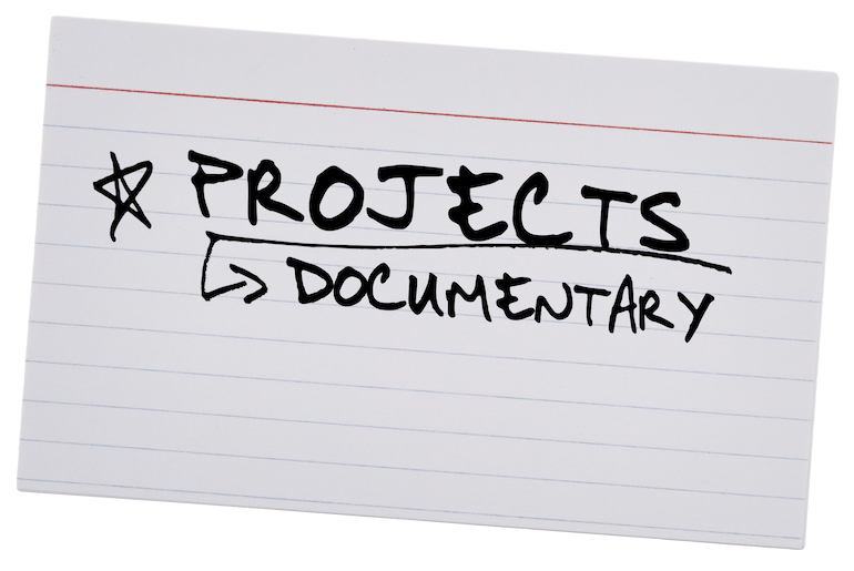 A white index card with handwritten black text reading 'Projects > Documentary' and a star symbol.