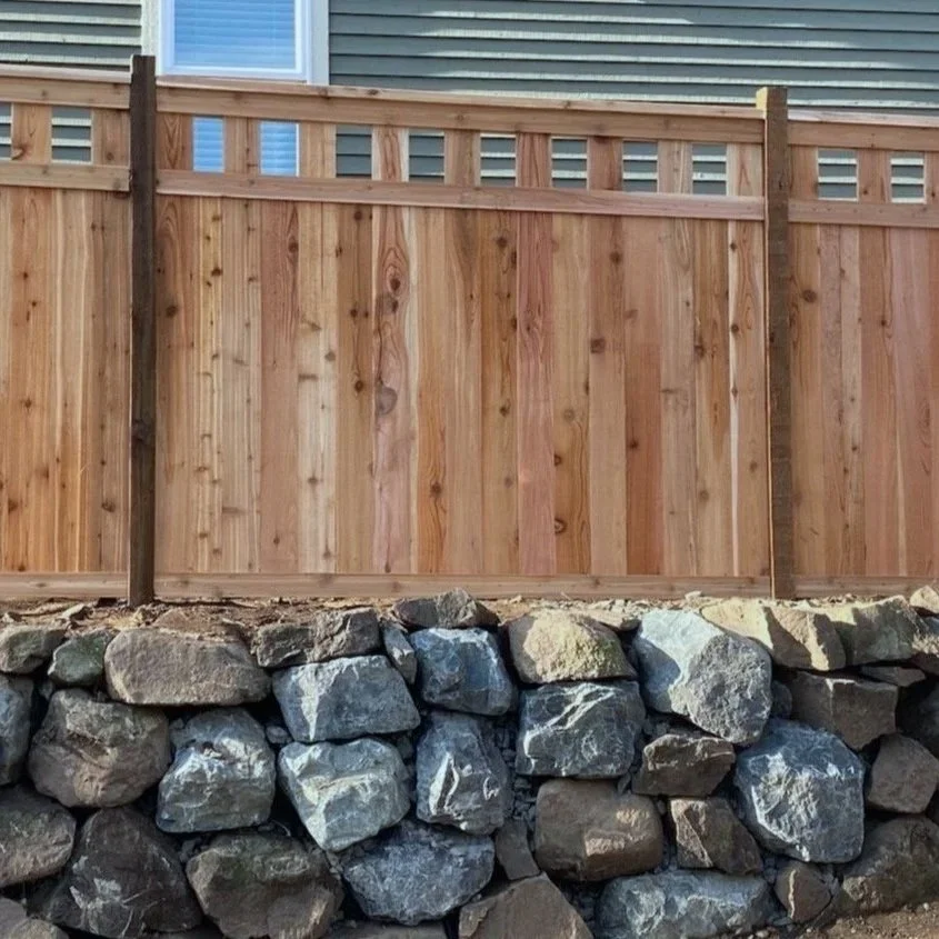 Cedar Alta privacy fencing on top of rockery wall