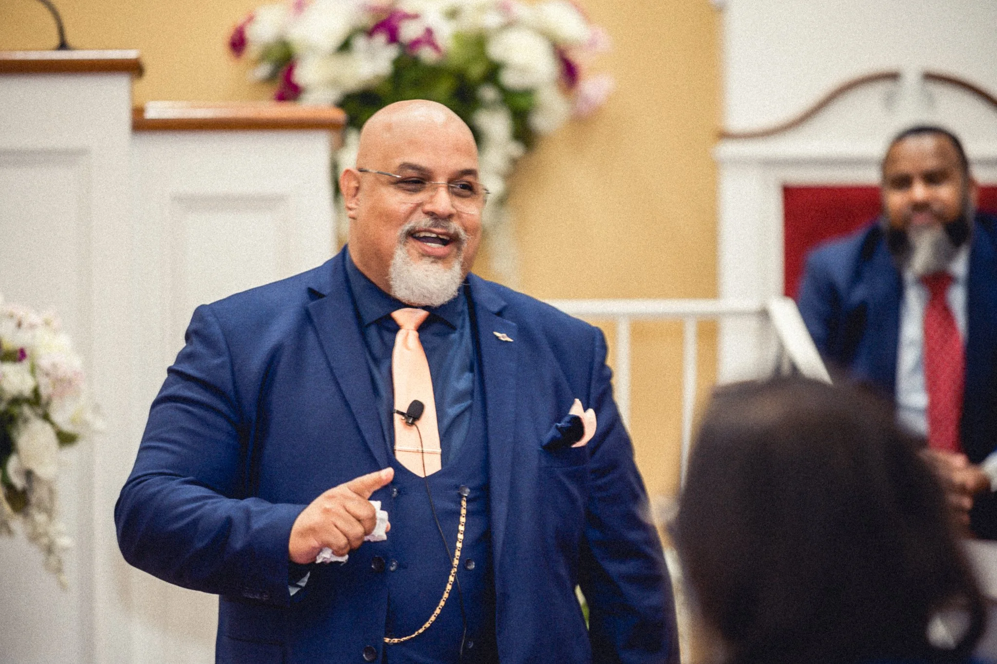 photo of older black preacher wearing dark blue suit speaking at church event. photo taken by expert event photographer in detroit and se michigan