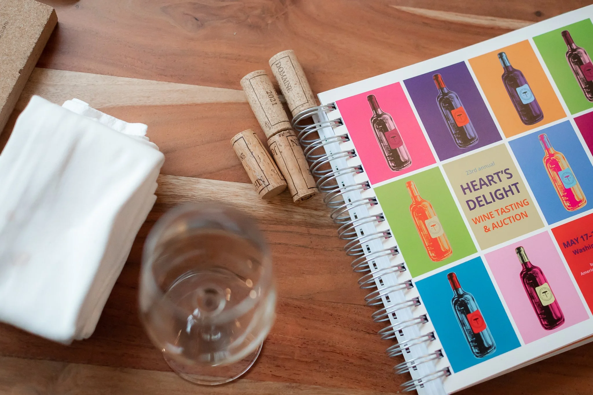 photo of american heart association heart's delight event booklet and wine corks. photo taken by black woman corporate event photographer in southeast michigan