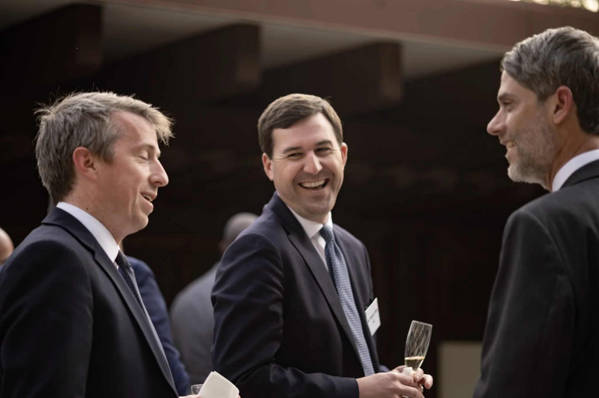 photo of two white businessmen talking and laughing with each other. photo taken by expert event photographer in detroit and se michigan