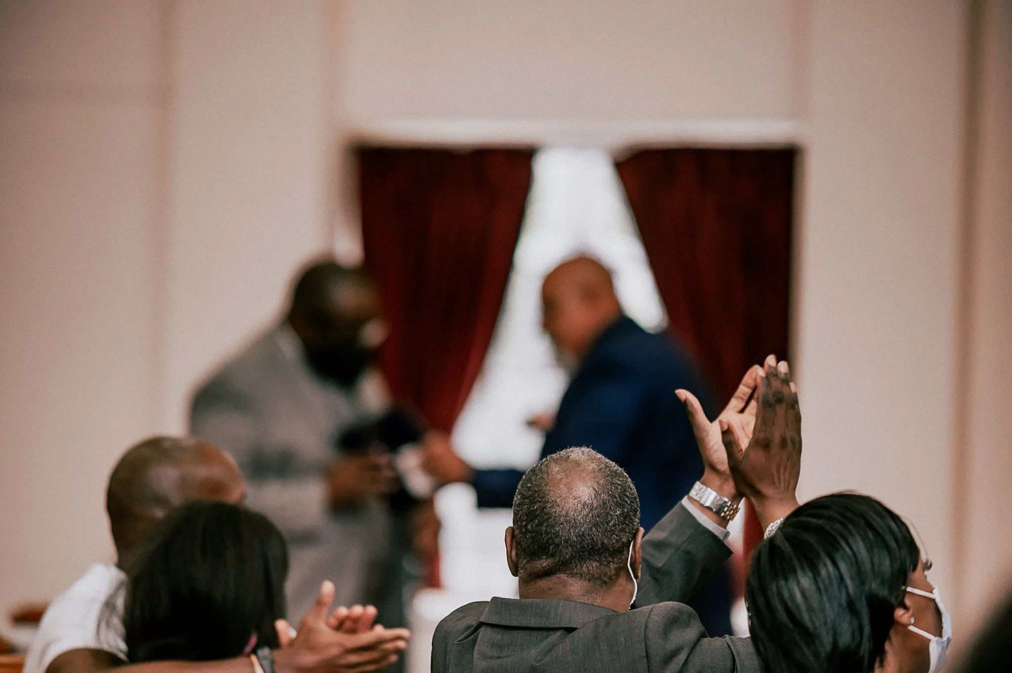 photo of older man clapping for preachers at a church event. photo taken by expert event photographer in detroit and se michigan