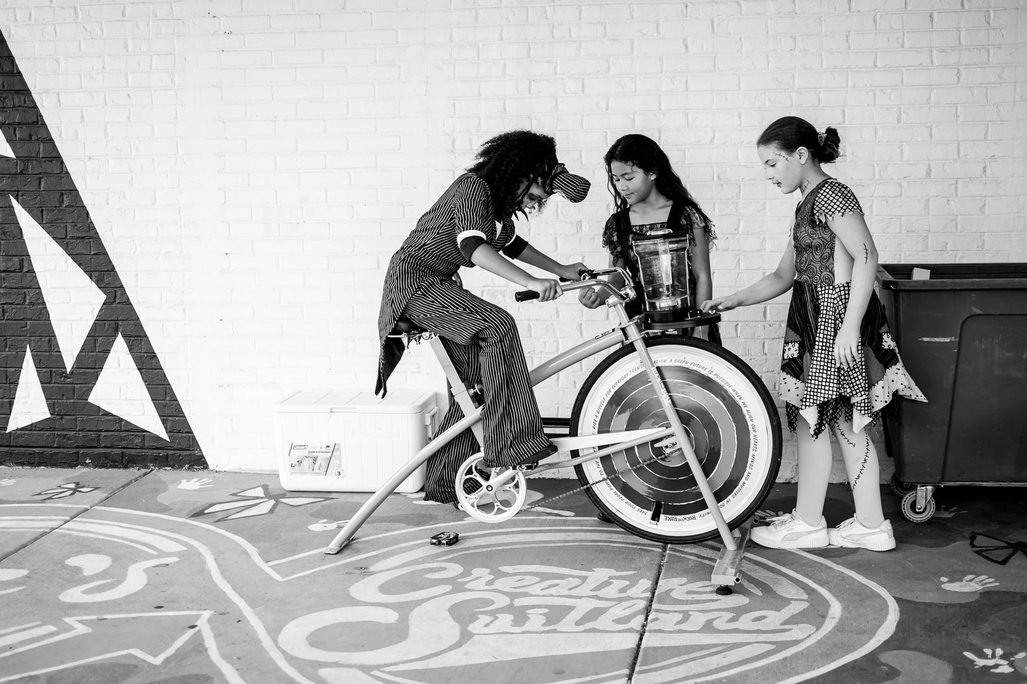 photo of young teens riding smoothie bike at farmers market event. photo taken by black woman event photographer in metro detroit michigan