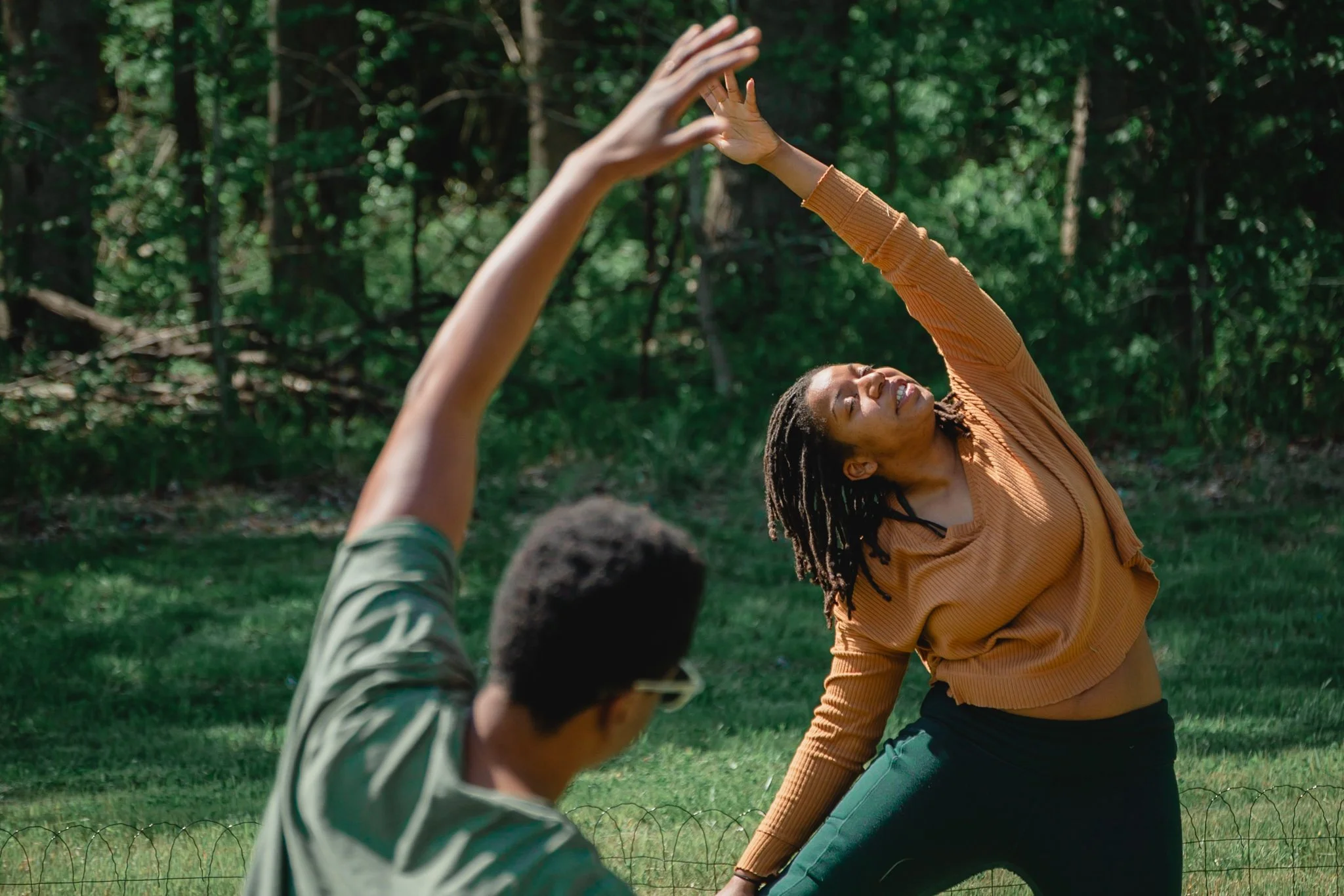 photo of black yoga instructor and student posing together. photo taken by black woman professional event photographer in southeast michigan