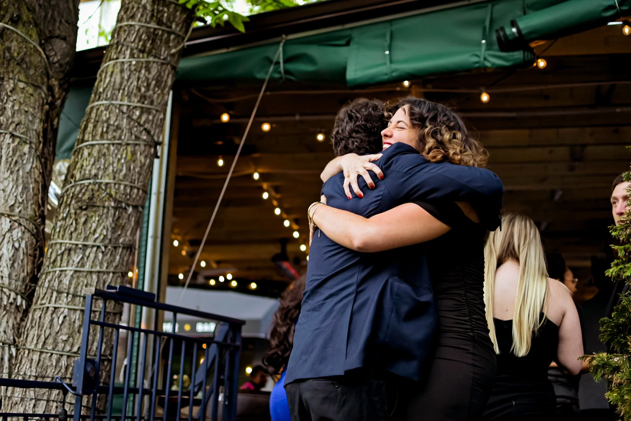 photo of two young law professionals hugging at law event. photo taken by professional event photographer in metro detroit michigan