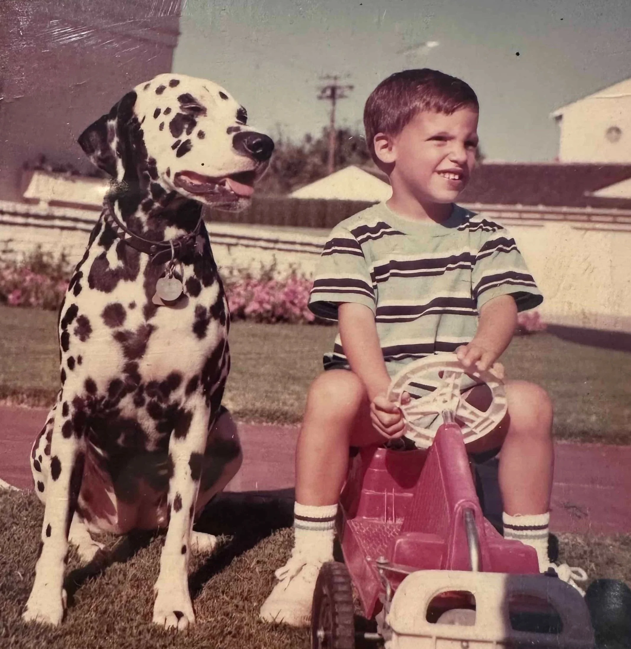In front of my childhood home with my best friend, Dotsy the Dalmatian.