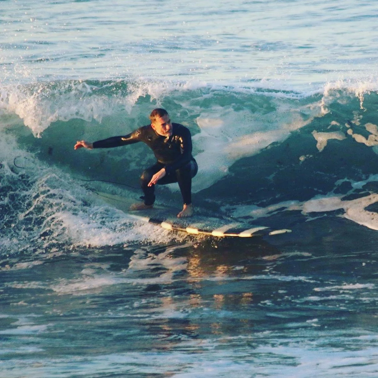 Riding a wave in Venice Beach.