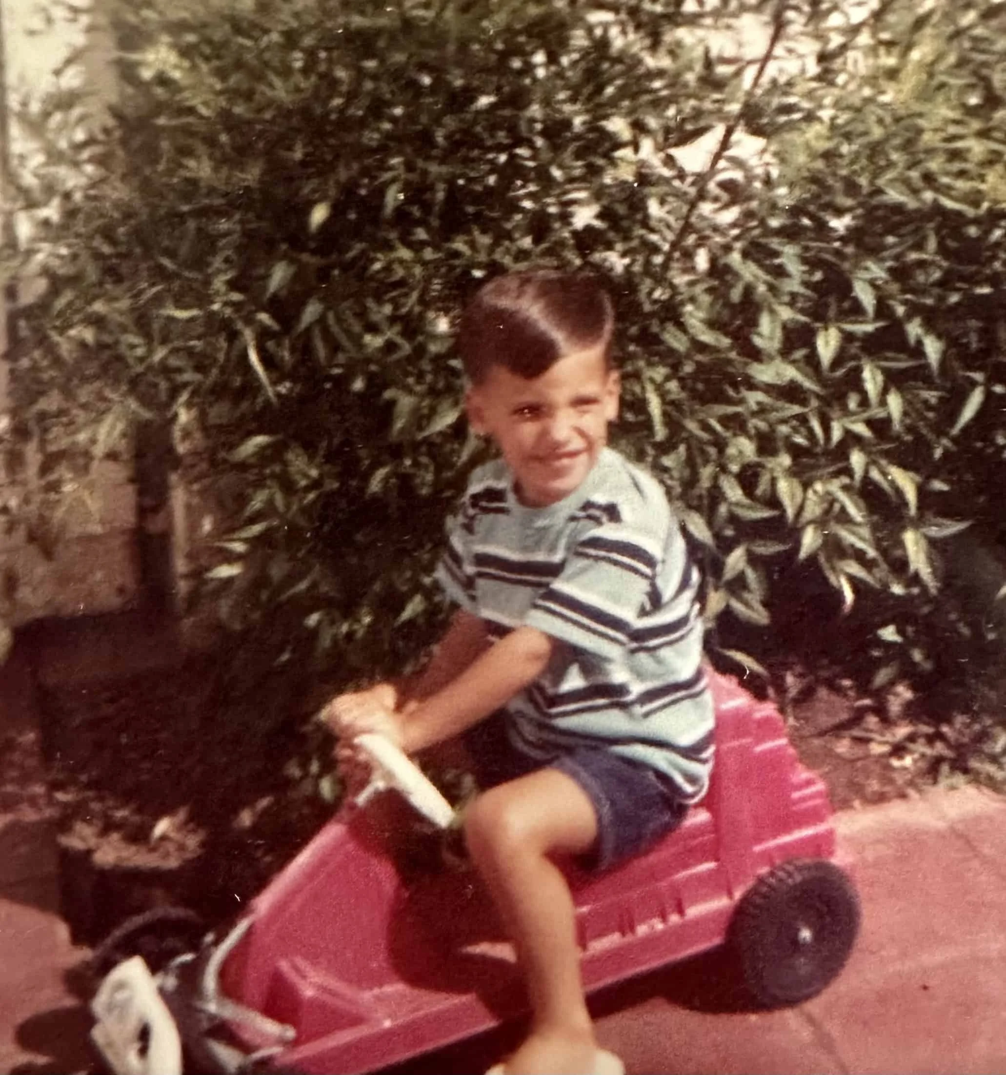 Riding my fire engine red wagon as an innocent child.